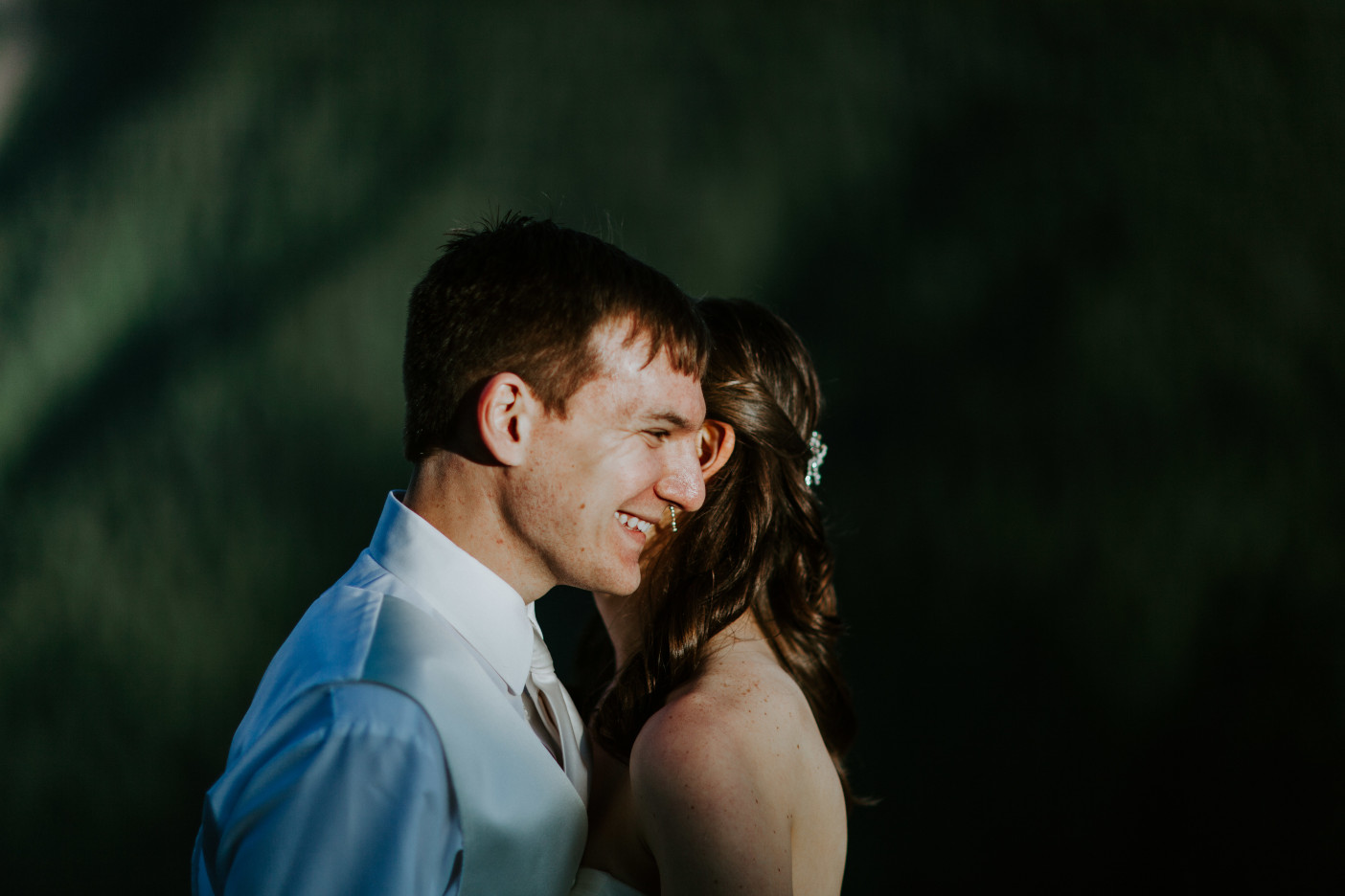 Moira whispers to Ryan in front of Mount Hood. Adventure elopement wedding shoot by Sienna Plus Josh.