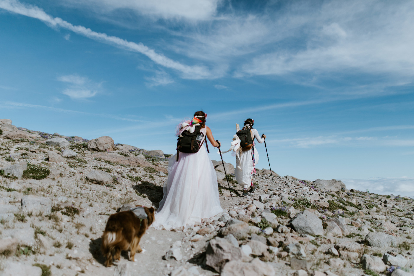 Heather and Margaux trek up the long ascent. Elopement photography at Mount Hood by Sienna Plus Josh.