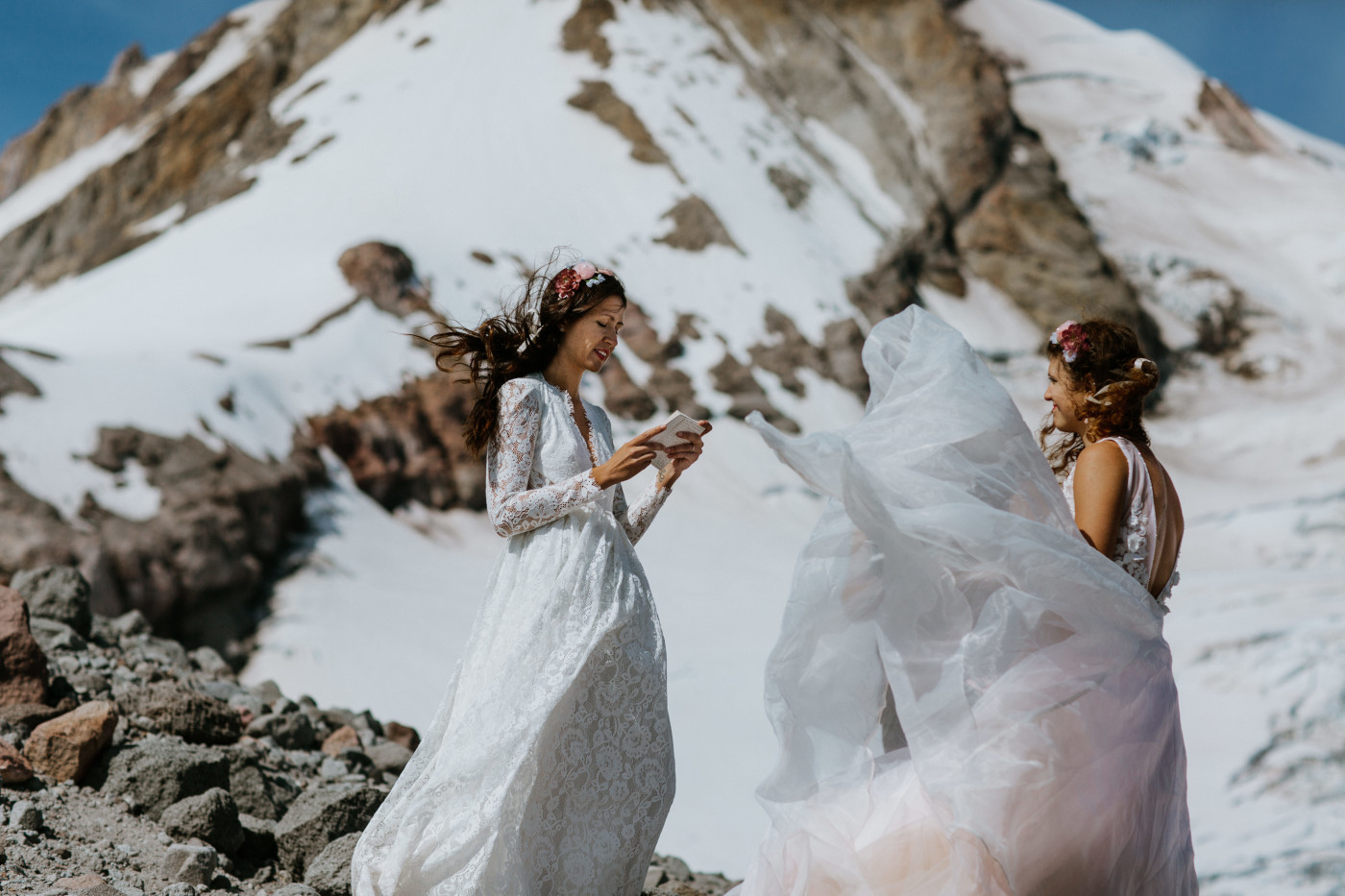 Margaux and Heather saying their vows during a wind gust. Elopement photography at Mount Hood by Sienna Plus Josh.