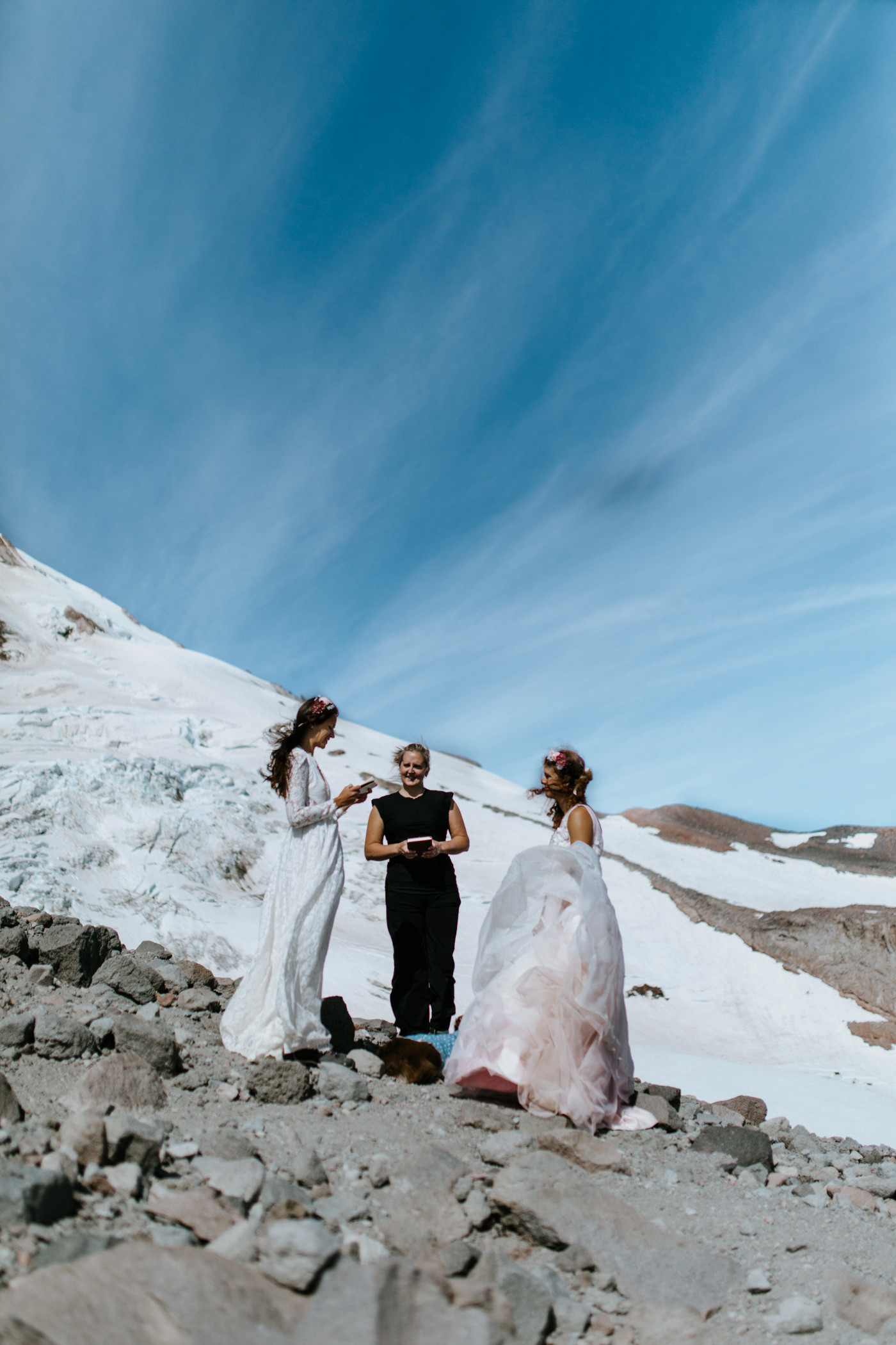 Heather and Margaux during their elopement ceremony with a view of the glaciers in the background. Elopement photography at Mount Hood by Sienna Plus Josh.