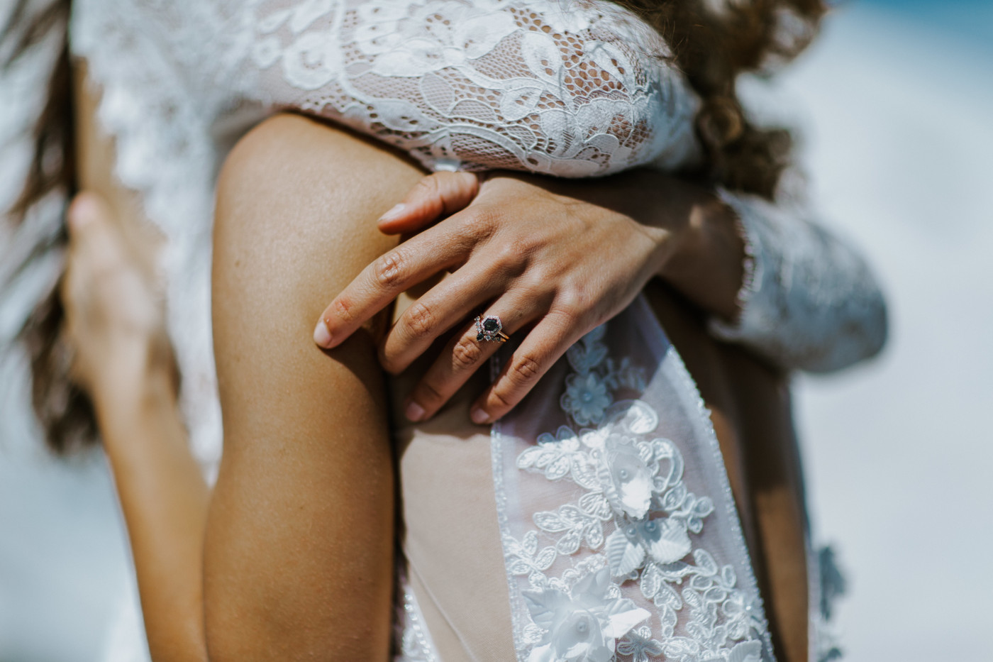 A close up of Margaux's ring as they hug. Elopement photography at Mount Hood by Sienna Plus Josh.