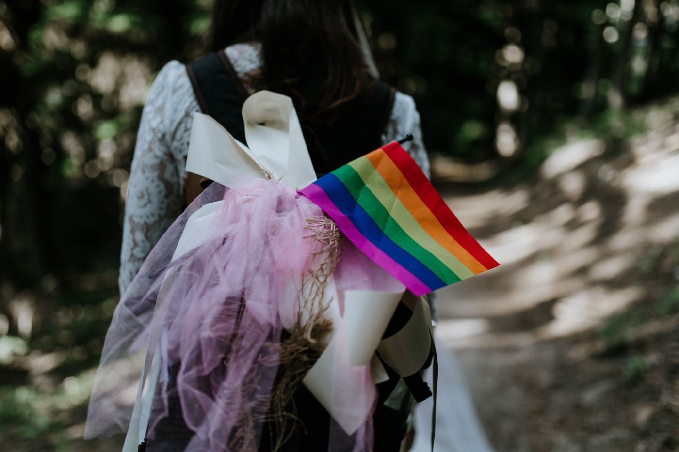 A close up of the pride flag hanging from Margaux's backpack. Elopement photography at Mount Hood by Sienna Plus Josh.