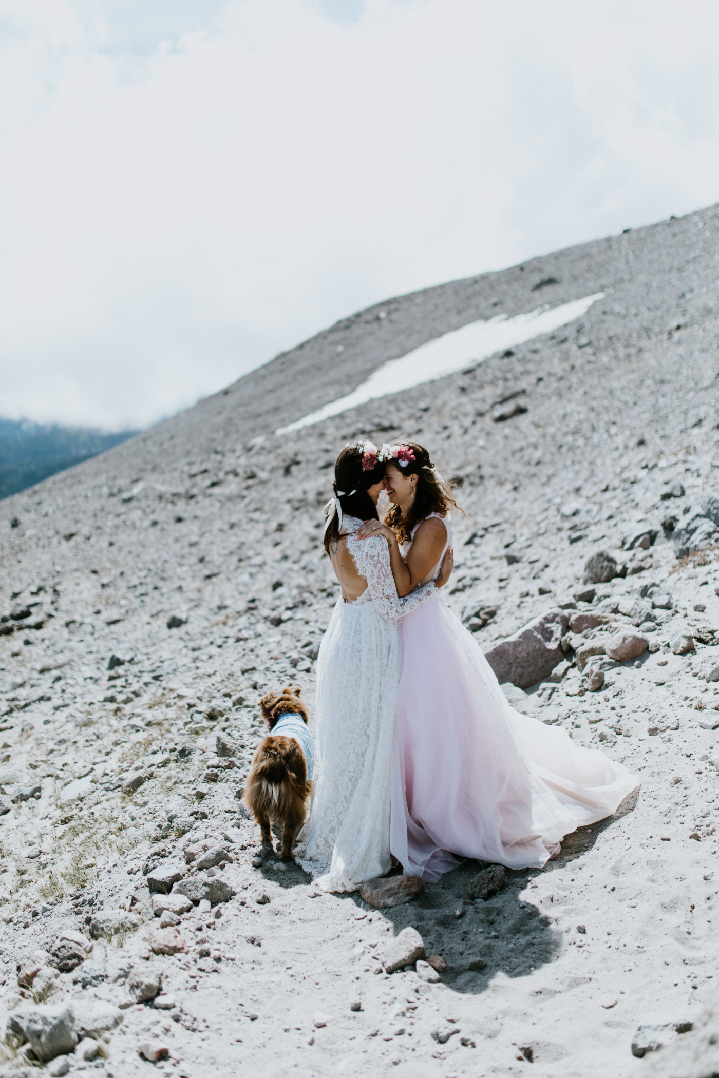 Margaux and Heather stand forehead to forehead along the rocks. Elopement photography at Mount Hood by Sienna Plus Josh.