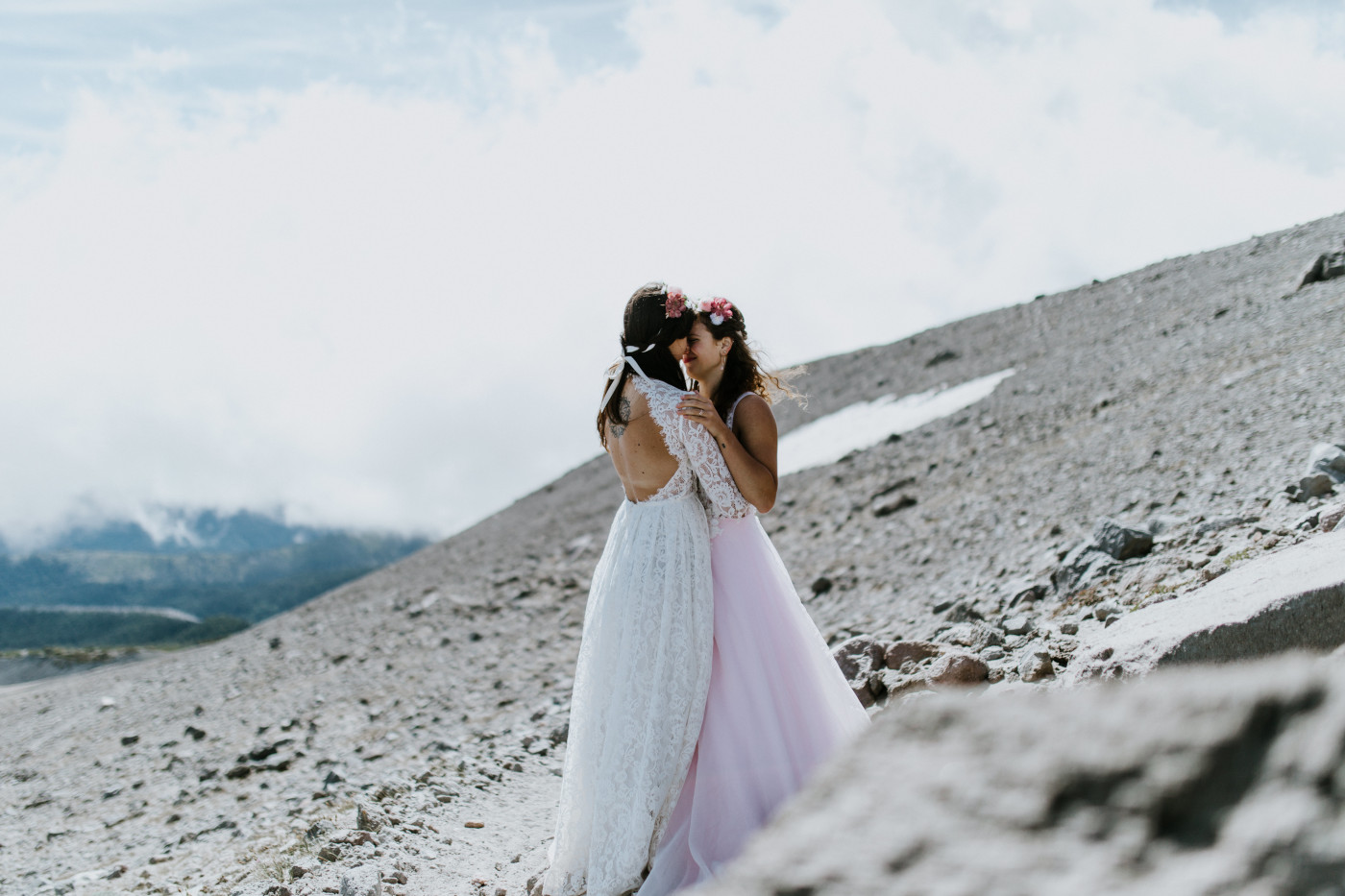 Margaux and Heather stand among the rocks of Mount Hood. Elopement photography at Mount Hood by Sienna Plus Josh.