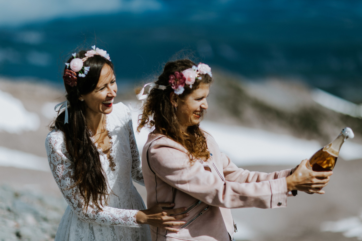 Margaux and Heather popping a bottle of champagne. Elopement photography at Mount Hood by Sienna Plus Josh.