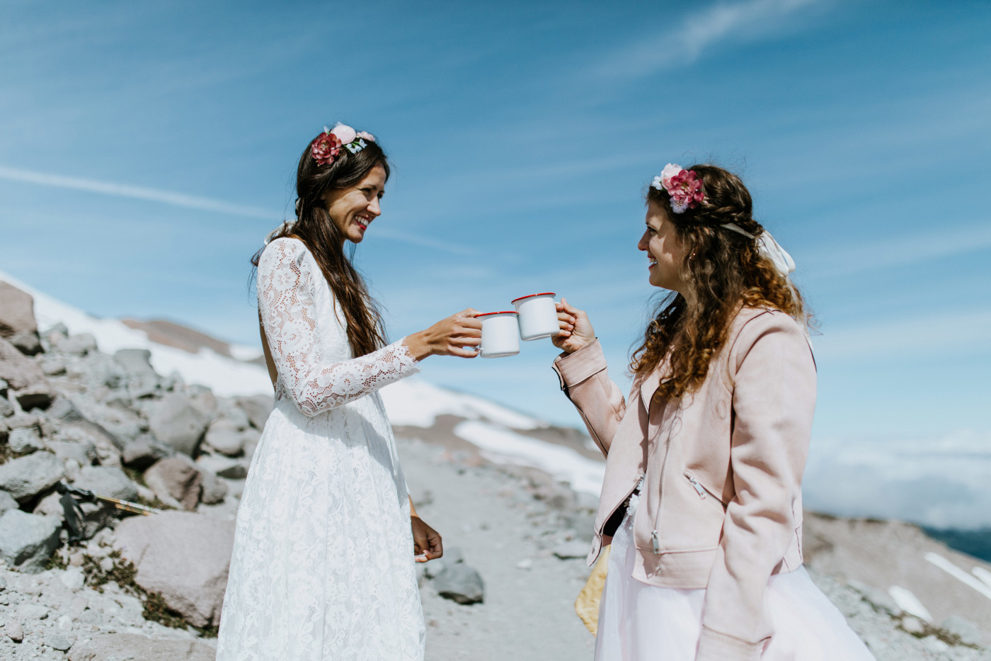 Margaux and Heather cheers with champagne atop Mount Hood during their elopement. Elopement photography at Mount Hood by Sienna Plus Josh.