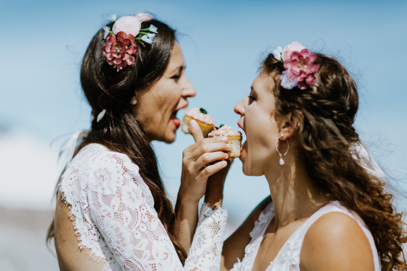 Margaux and Heather interlace their arms to eat their wedding cupcakes. Elopement photography at Mount Hood by Sienna Plus Josh.