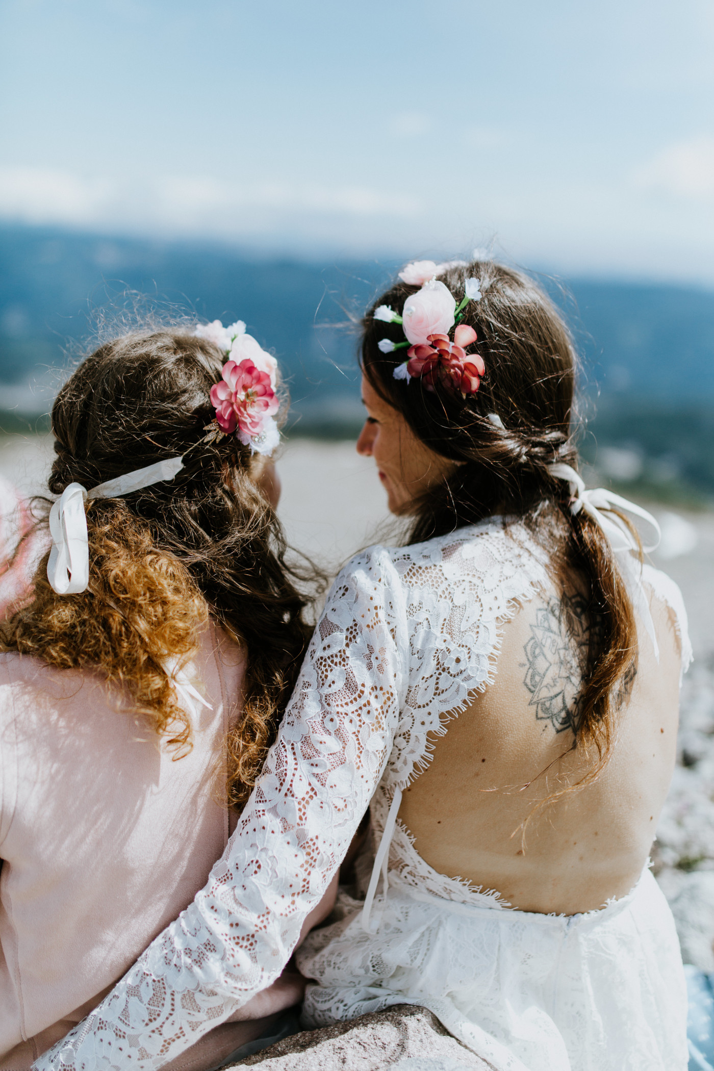 Margaux and Heather sit side by side and enjoy the view. Elopement photography at Mount Hood by Sienna Plus Josh.