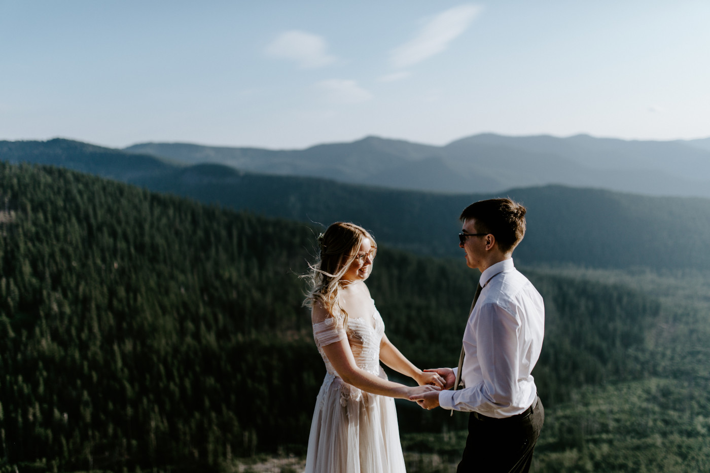 Corey and Kylie stand together and hold hands in Mount Hood National Forest.