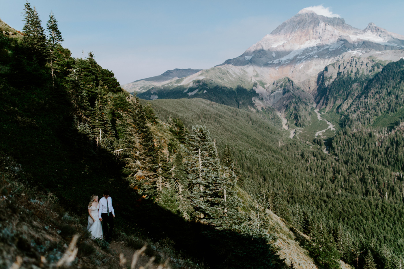 Kylie and Corey walk away from Mount Hood on a trail.