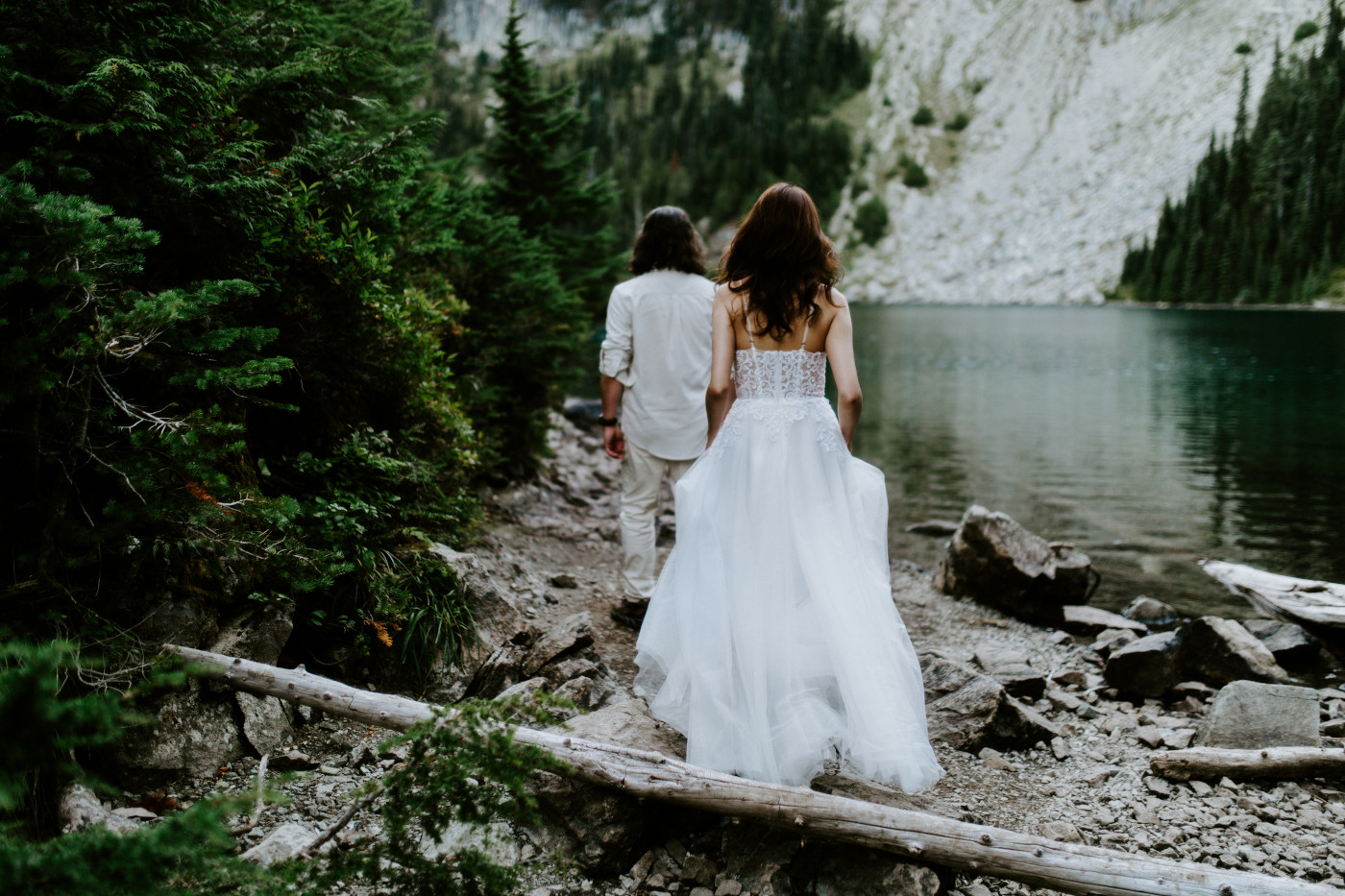 Matthew and Katrina walk near a lake at Mount Rainier for their elopement.