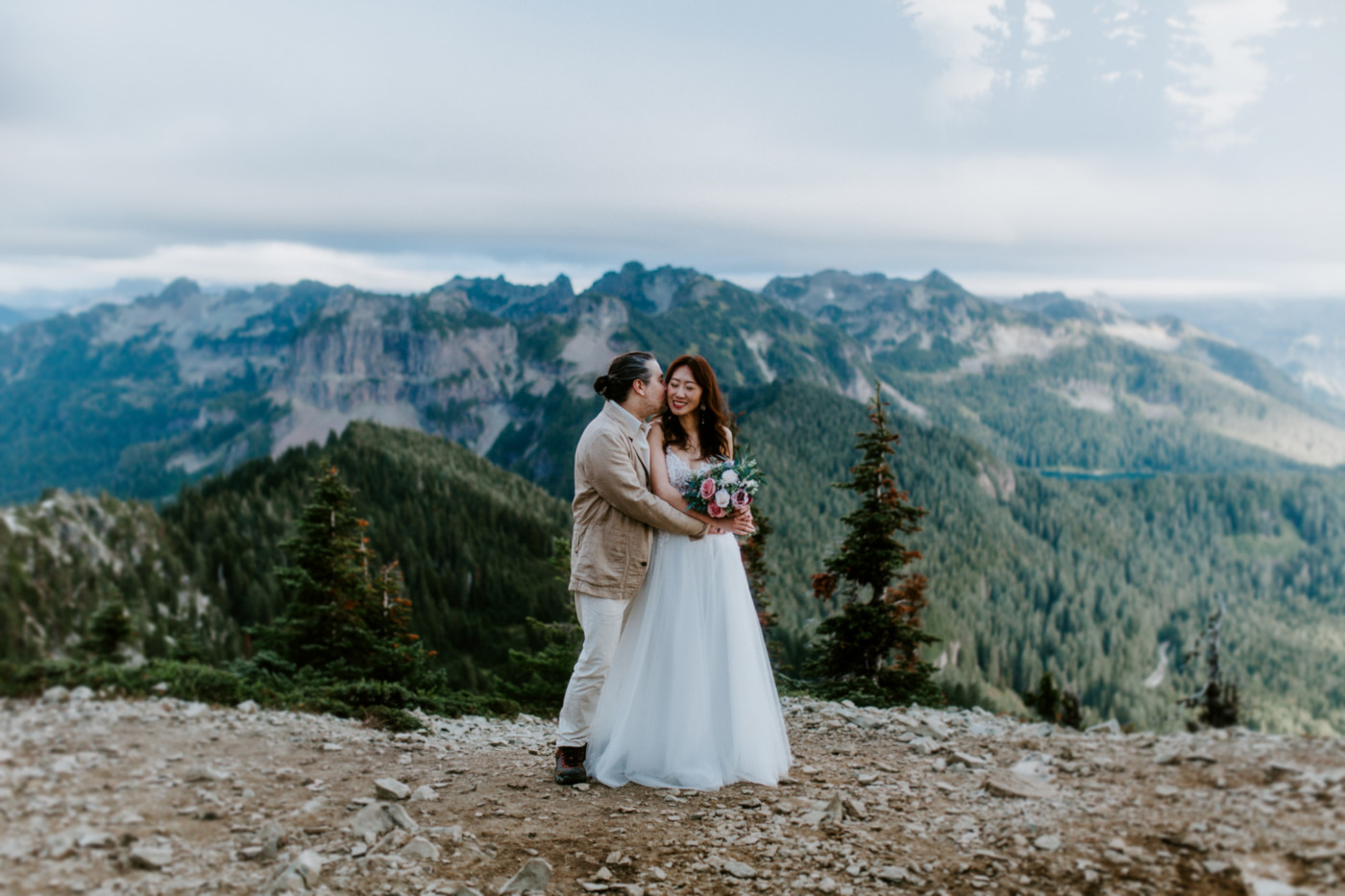 Matthew kisses Katrina on top of Mount Rainier, Washington during their elopement.