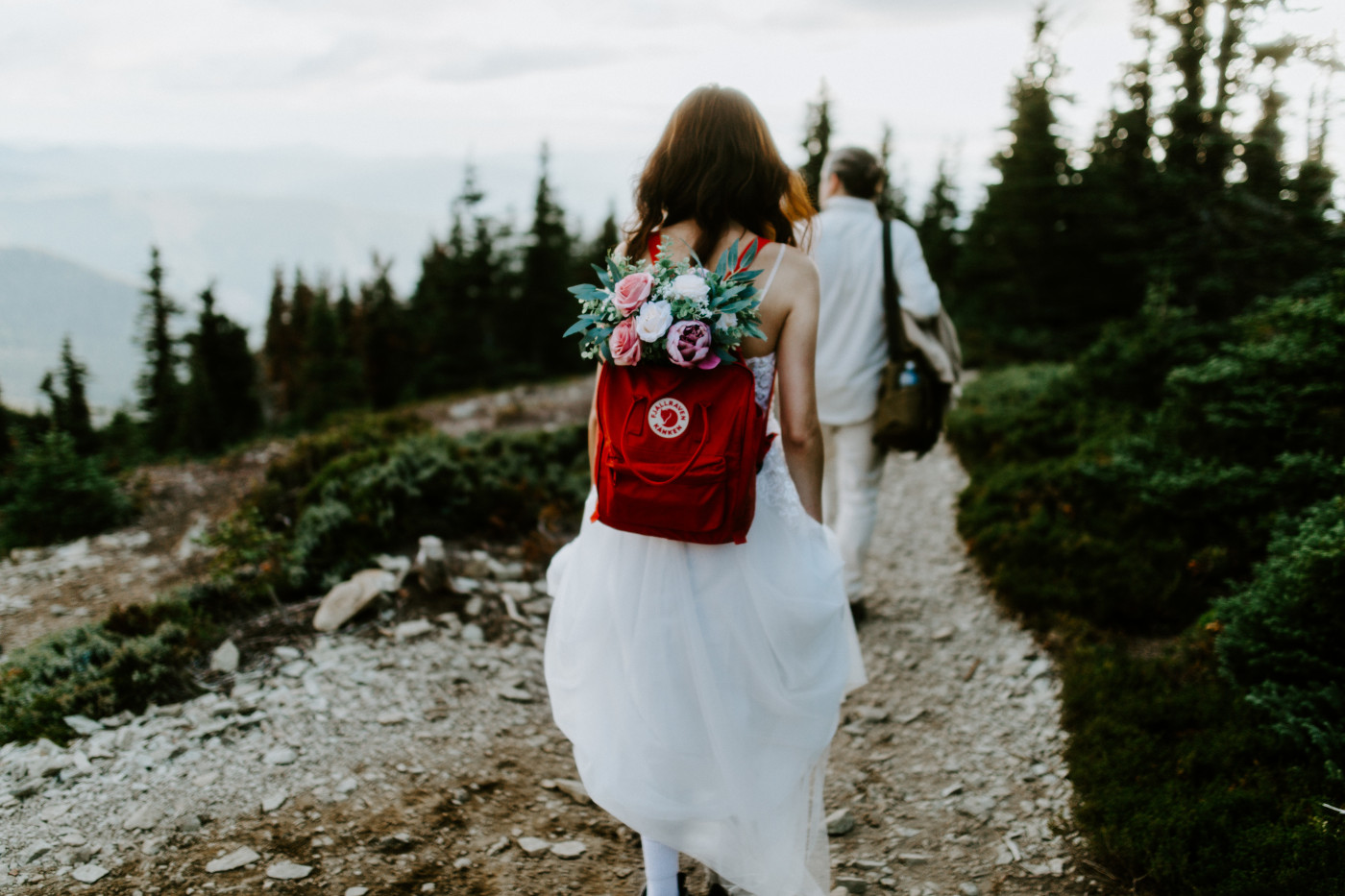 Katrina and Matthew hike down the path at Mount Rainier after their elopement.