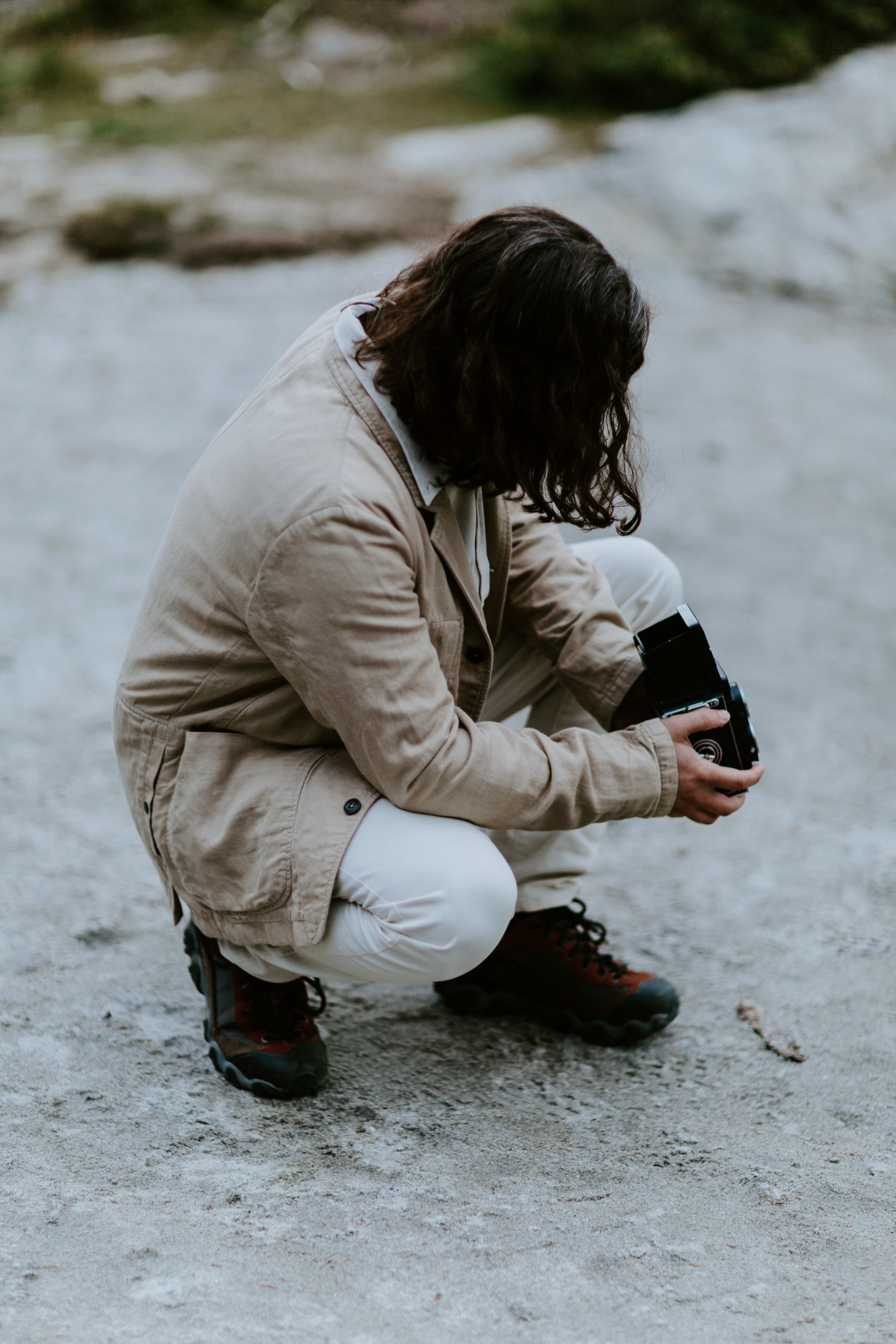 Matthew takes a picture with his film camera at a lake at Mount Rainier for his elopement.