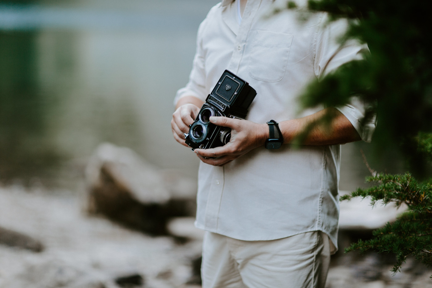 Matthew holds his film camera before his Mount Rainier elopement.