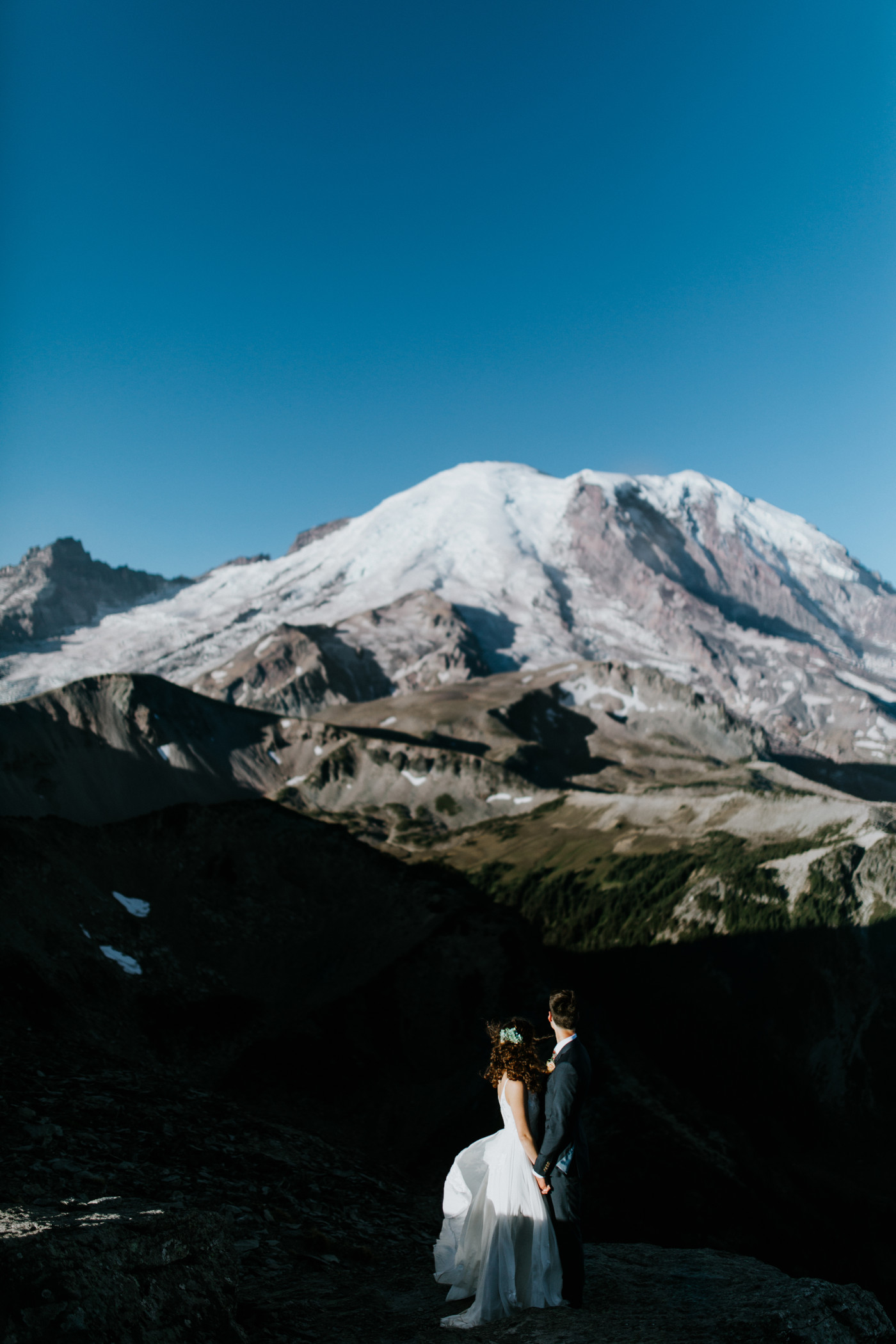 Chad and Tasha look at Mount Rainier. Elopement photography at Mount Rainier by Sienna Plus Josh.