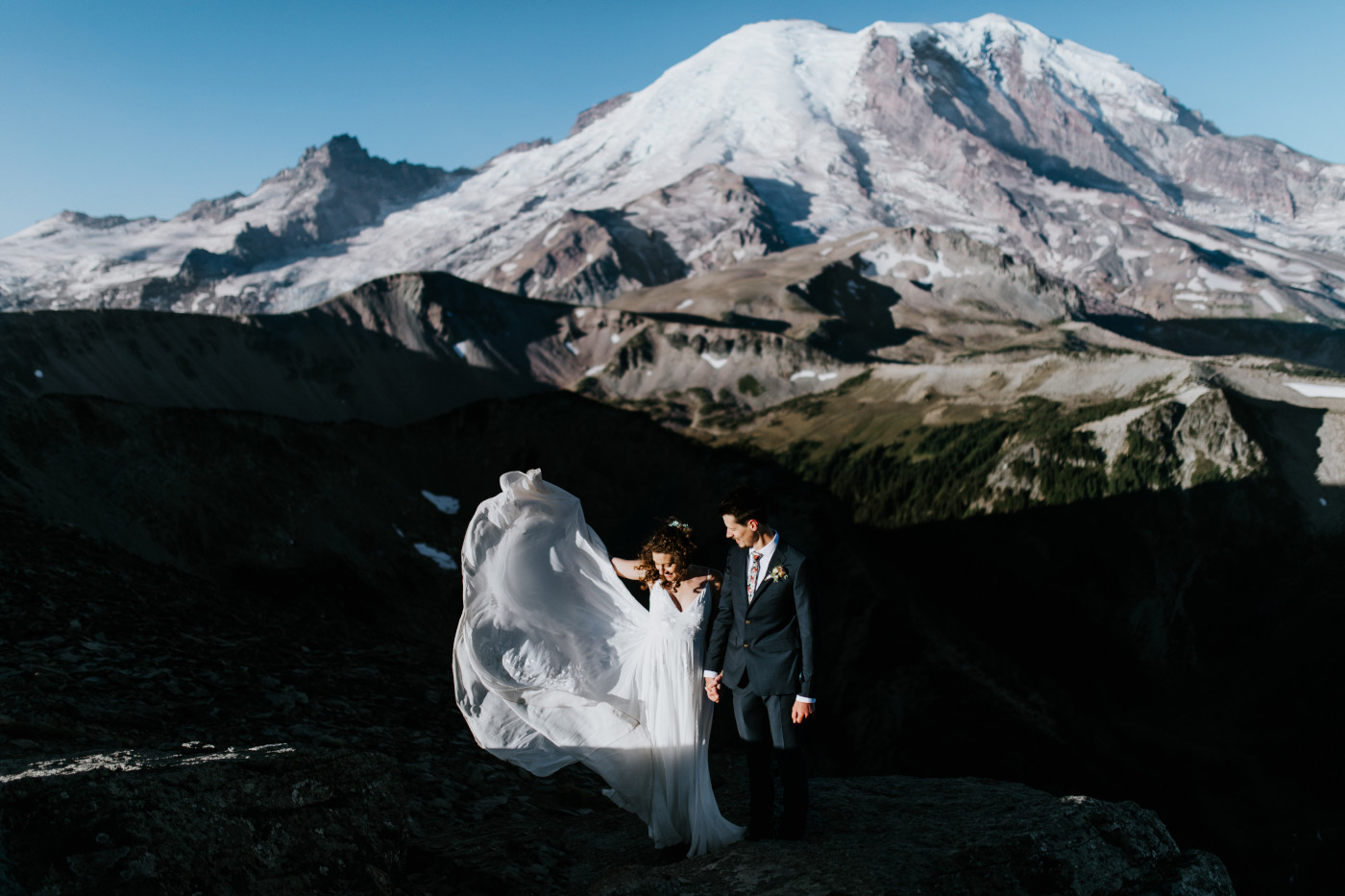 Chad and Tasha look at the dress. Elopement photography at Mount Rainier by Sienna Plus Josh.