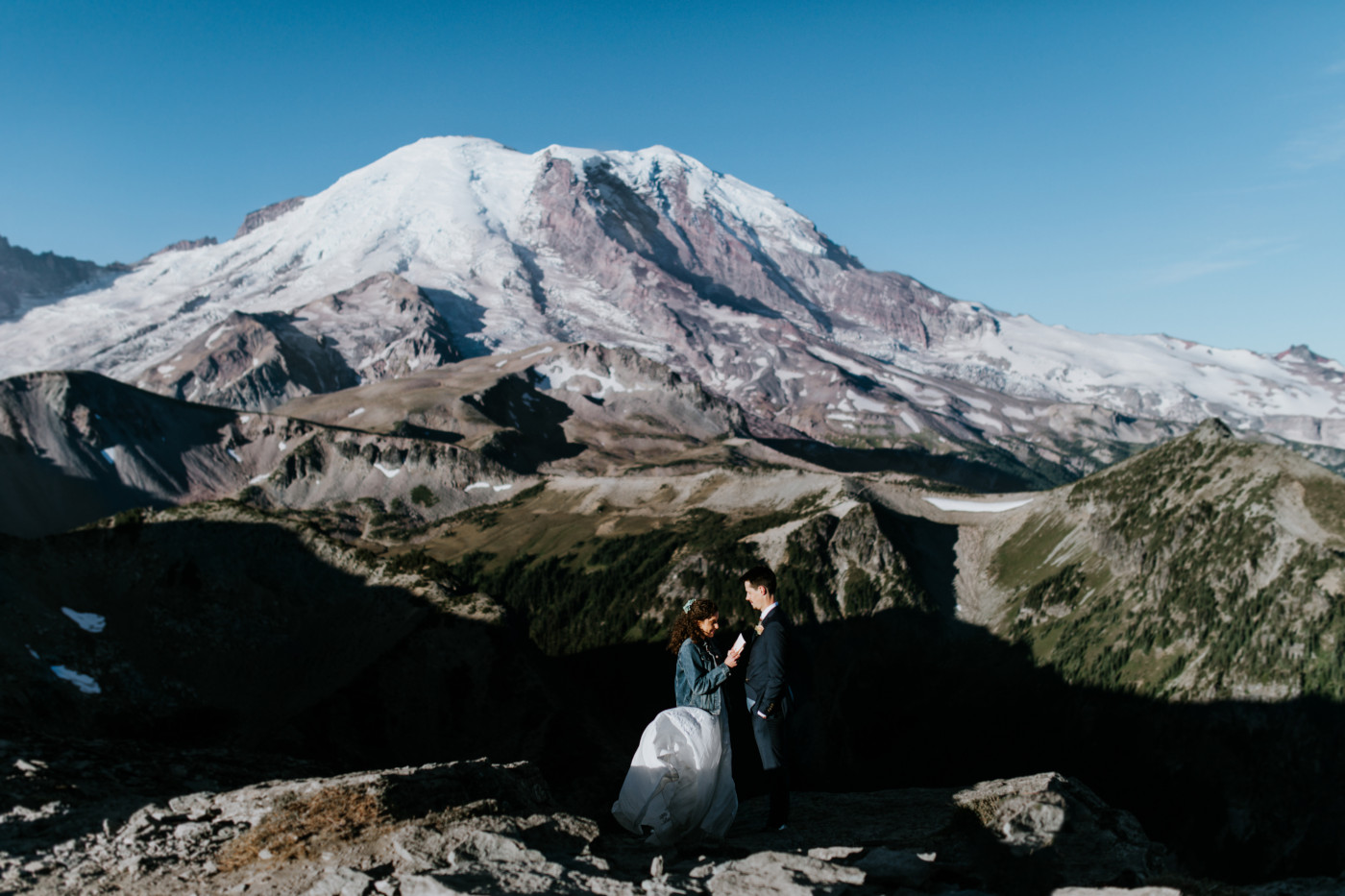 Tasha and chad at their eleopement spot with a view of the mountain. Elopement photography at Mount Rainier by Sienna Plus Josh.