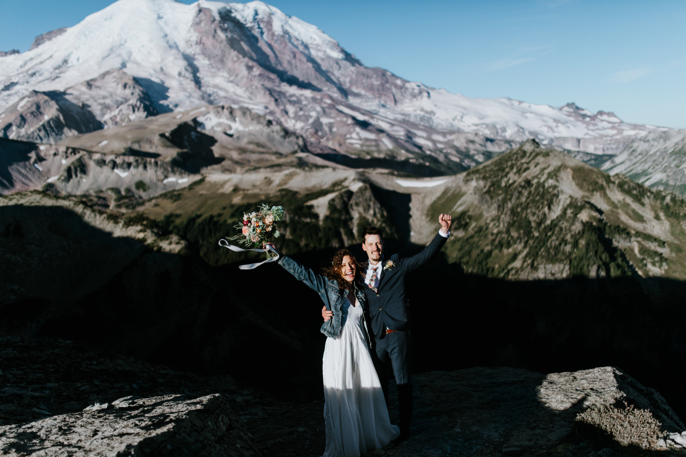 Tasha and Chad stand together and celebrate. Elopement photography at Mount Rainier by Sienna Plus Josh.