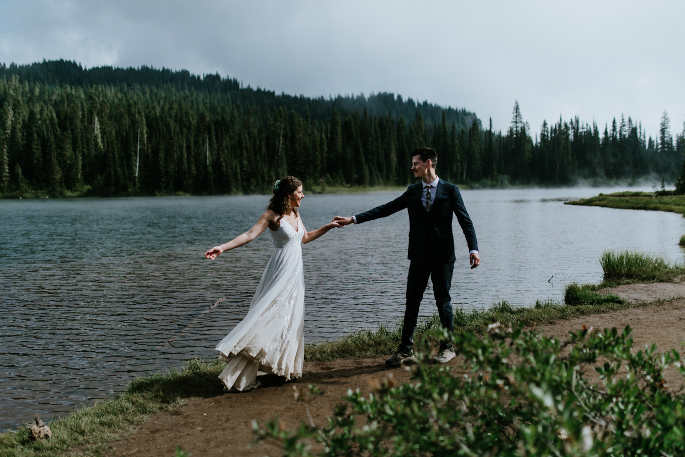 Tasha and Chad dance near a lake. Elopement photography at Mount Rainier by Sienna Plus Josh.