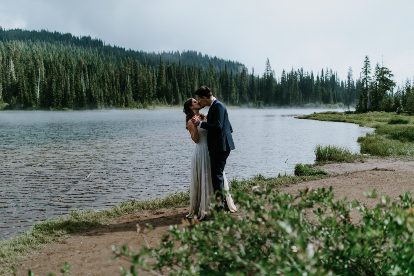 Chad and Tasha kiss near the lake. Elopement photography at Mount Rainier by Sienna Plus Josh.