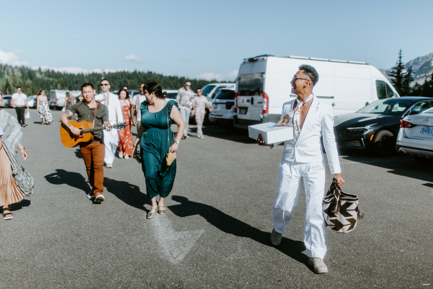 Fred and Brooks walk with their friends in Mount Rainier after their elopement.