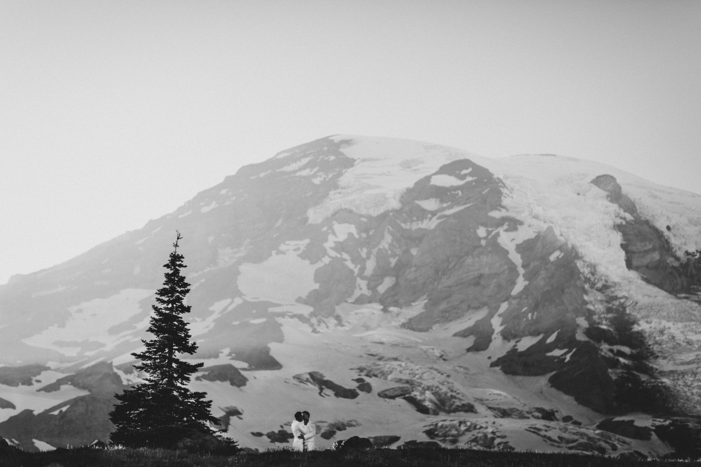 Fred and Brooks stand together in front of Mount Rainier after their elopement.