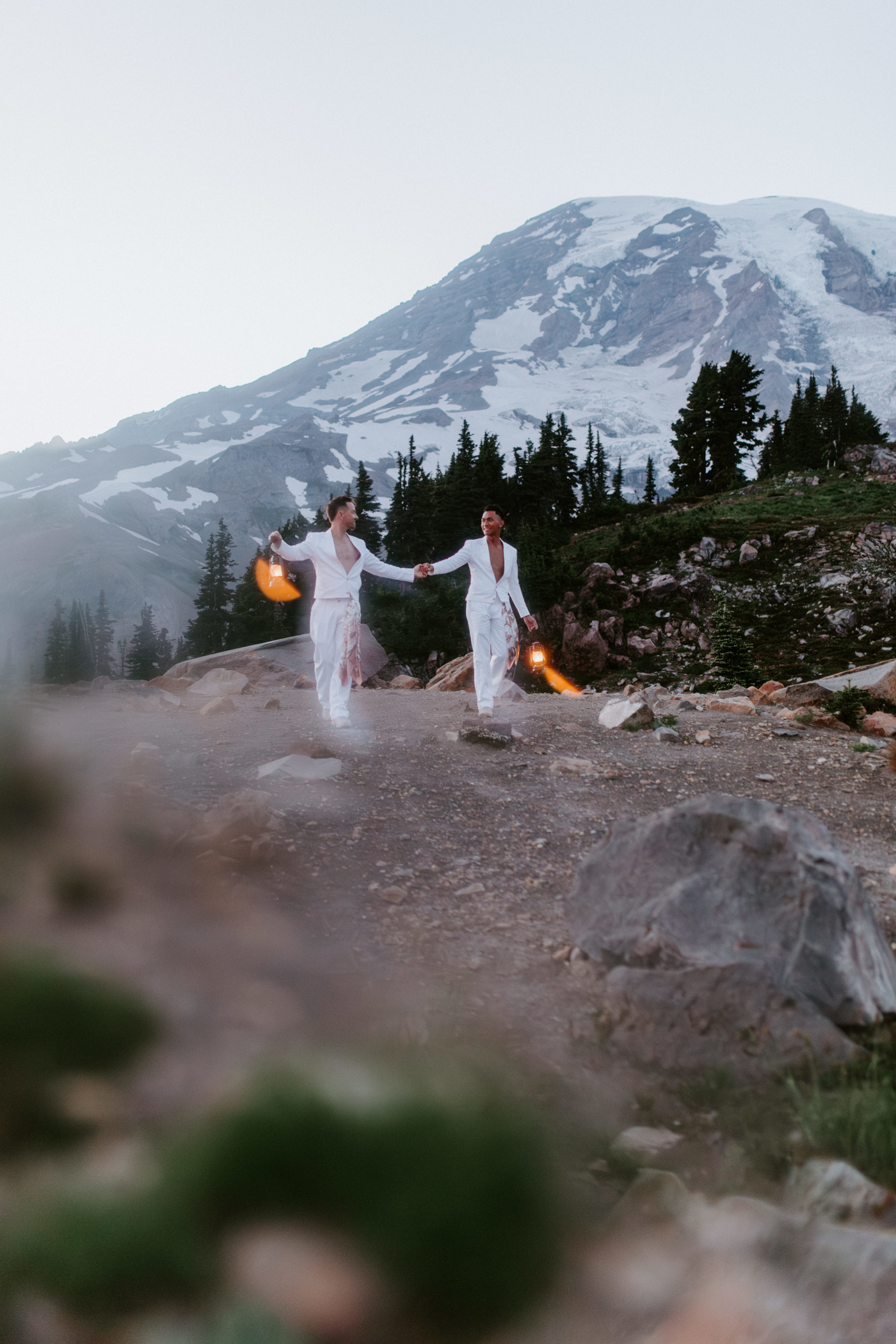 Brooks and Fred walk with lanterns in Mount Rainier, Washington after their elopement.