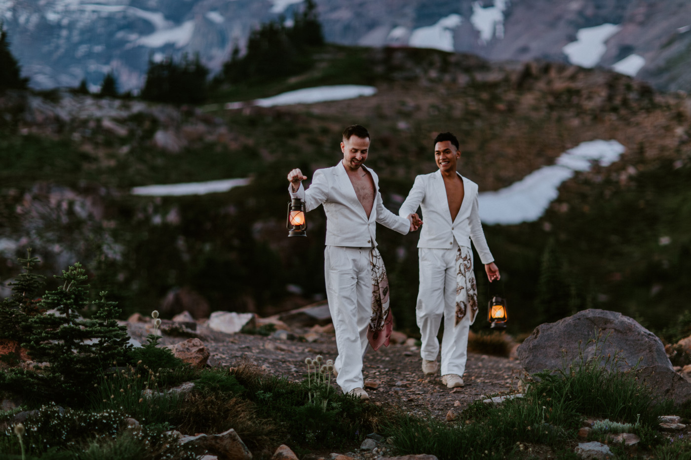 Brooks and Fred walk with lanterns in Mount Rainier.