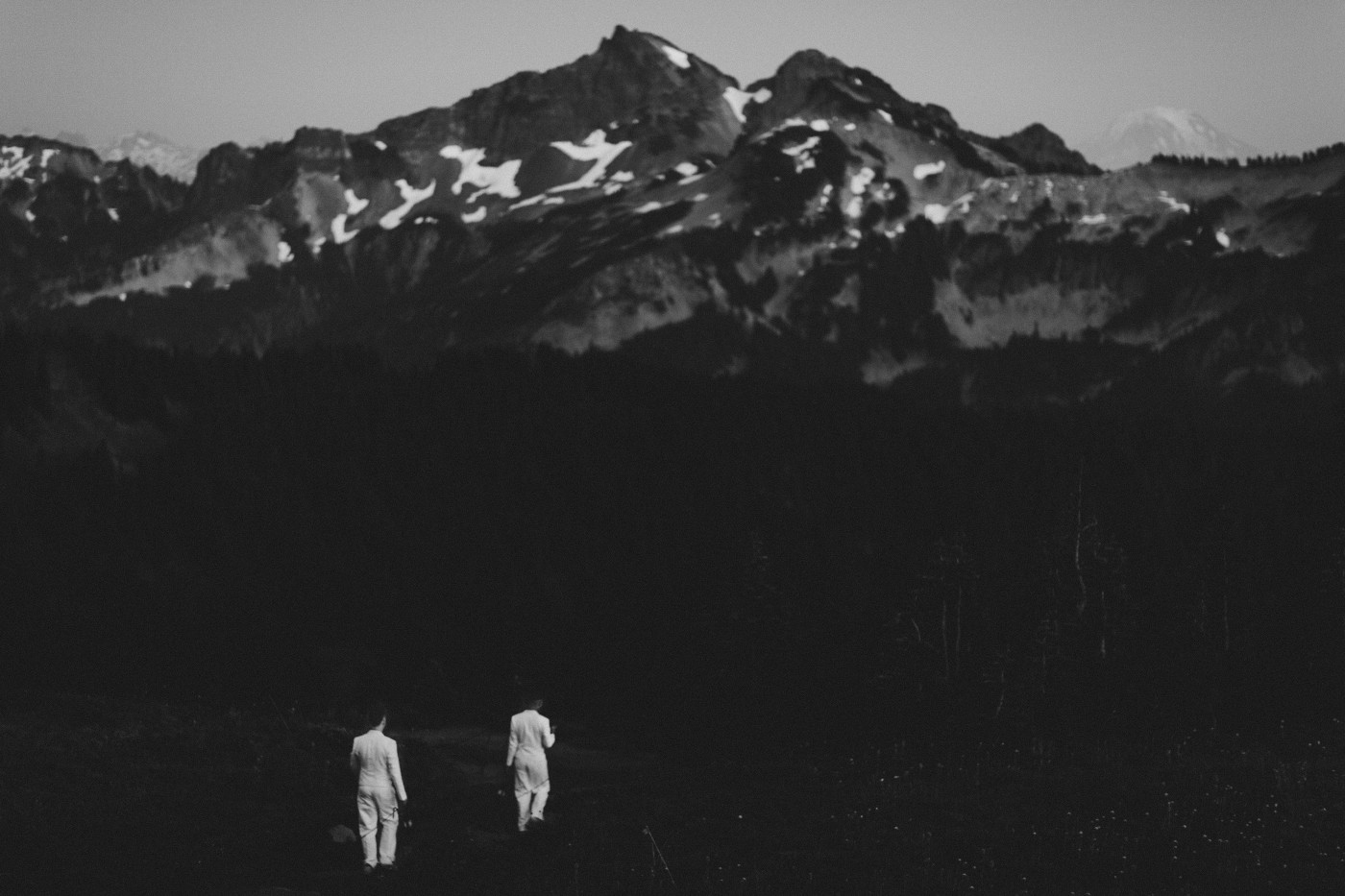 Fred and Brooks walk a trail at Mount Rainier, Washington after their elopement.