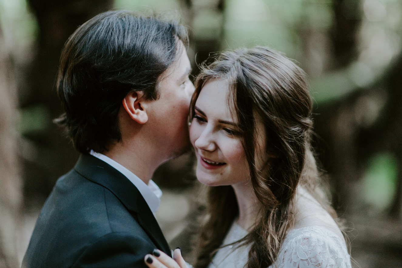 Vlad whispers into Nicole's ear. Elopement wedding photography at Cannon Beach by Sienna Plus Josh.