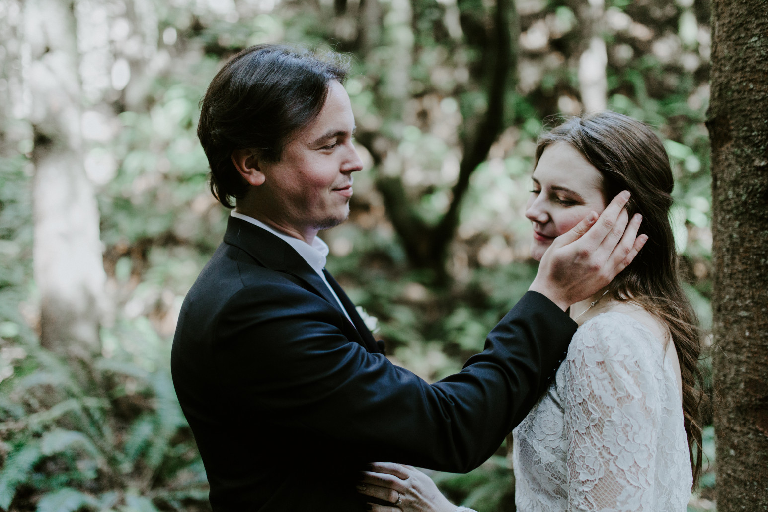 Vlad brushes Nicole's hair aside at Cannon Beach. Elopement wedding photography at Cannon Beach by Sienna Plus Josh.