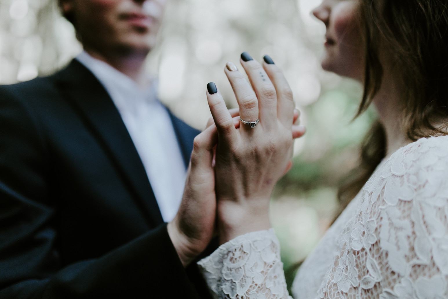 Nicole and Vlad touch each other's hands. Elopement wedding photography at Cannon Beach by Sienna Plus Josh.