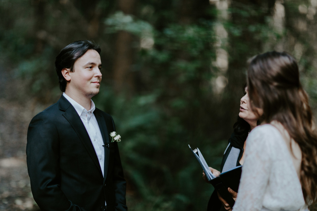 Nicole and Vlad stand at their elopement. Elopement wedding photography at Cannon Beach by Sienna Plus Josh.