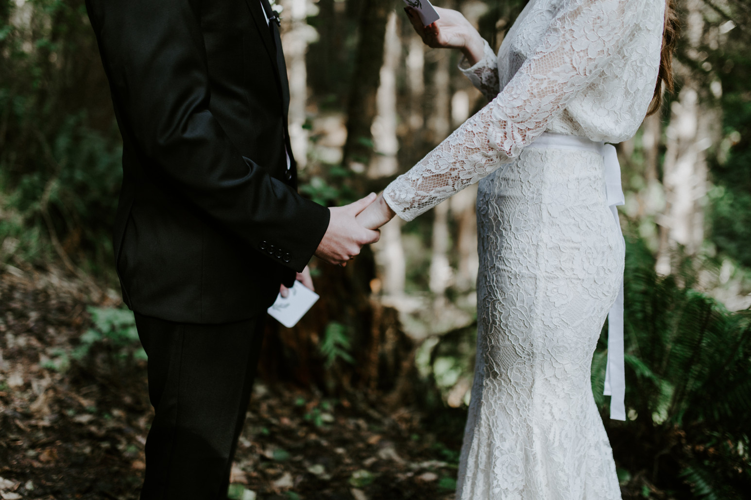 Nicole and Vlad hold hands during their elopement. Elopement wedding photography at Cannon Beach by Sienna Plus Josh.