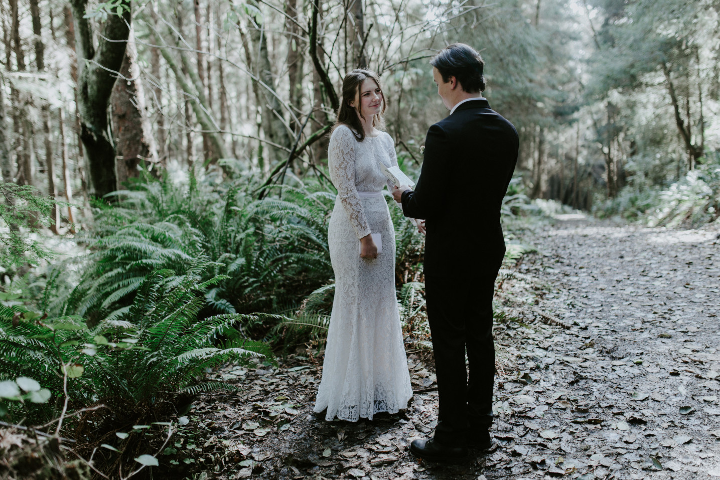 Vlad reads his vows to Nicole during their elopement. Elopement wedding photography at Cannon Beach by Sienna Plus Josh.