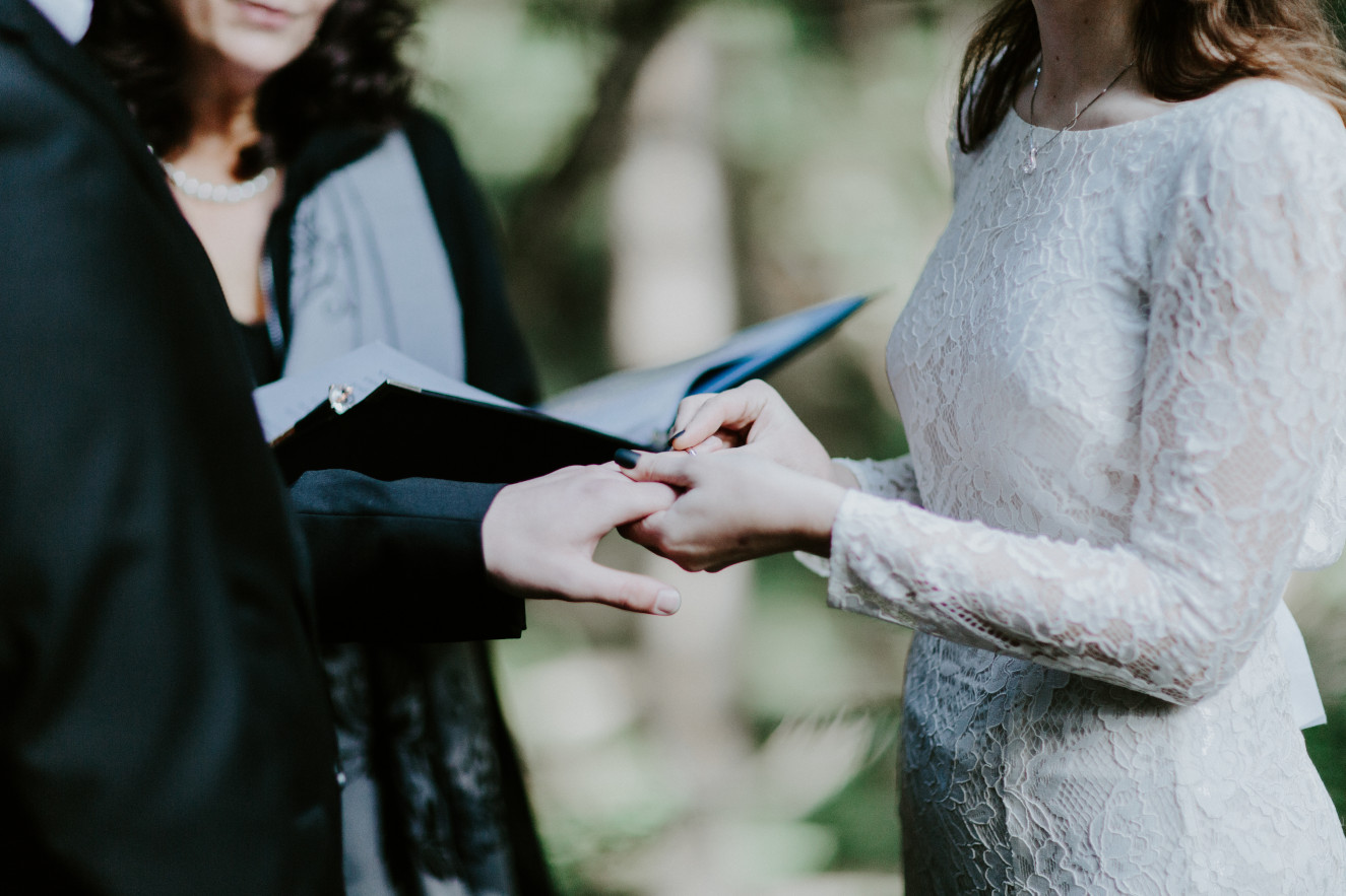 Nicole and Vlad exchange rings. Elopement wedding photography at Cannon Beach by Sienna Plus Josh.