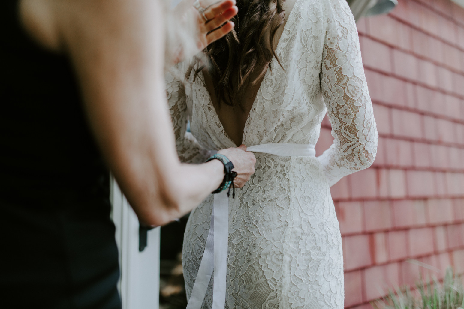 Nicole's mom helps her zip up her dress. Elopement wedding photography at Cannon Beach by Sienna Plus Josh.