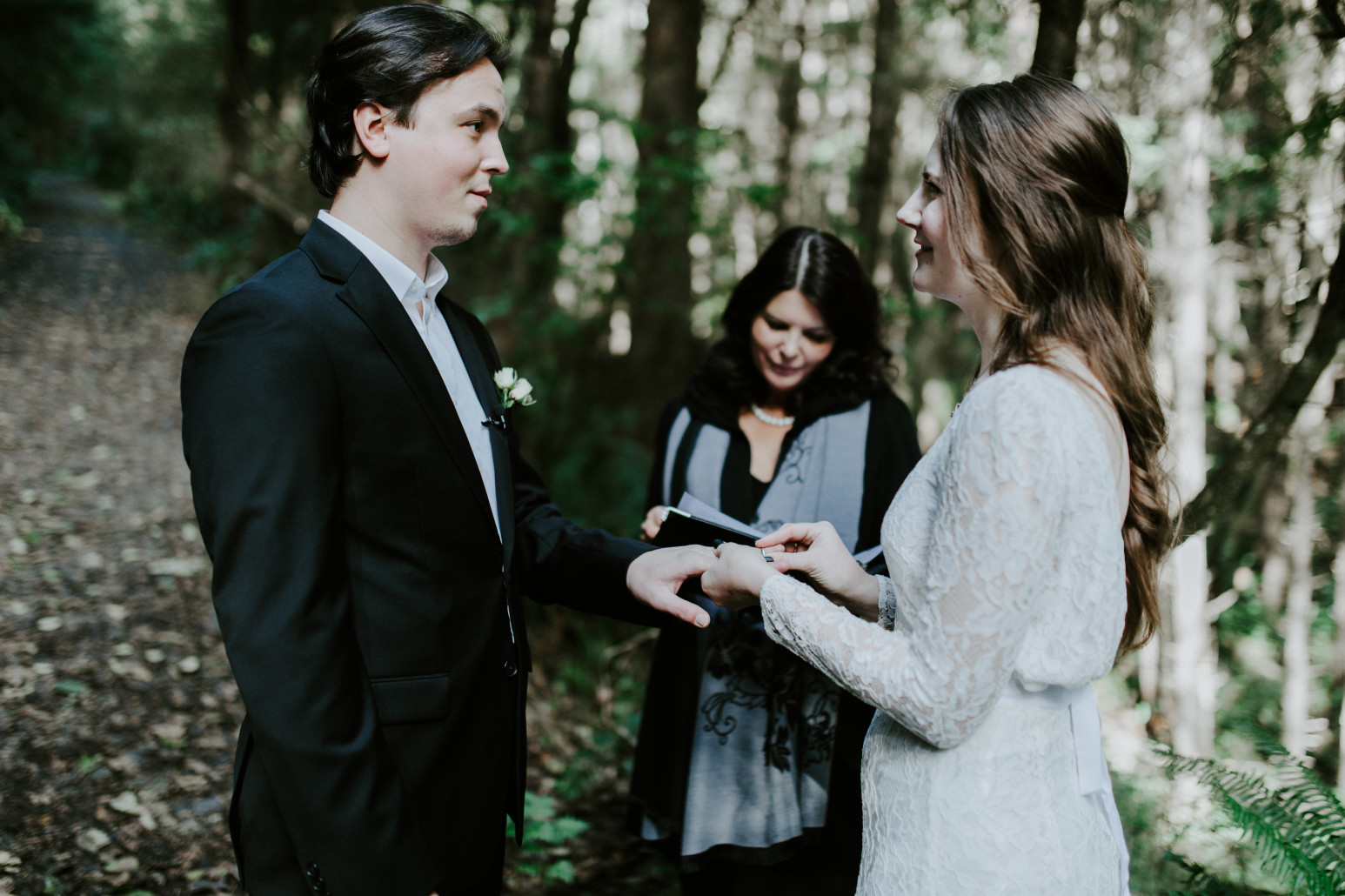 Nicole and Vlad exchange rings at Cannon Beach during their elopement. Elopement wedding photography at Cannon Beach by Sienna Plus Josh.