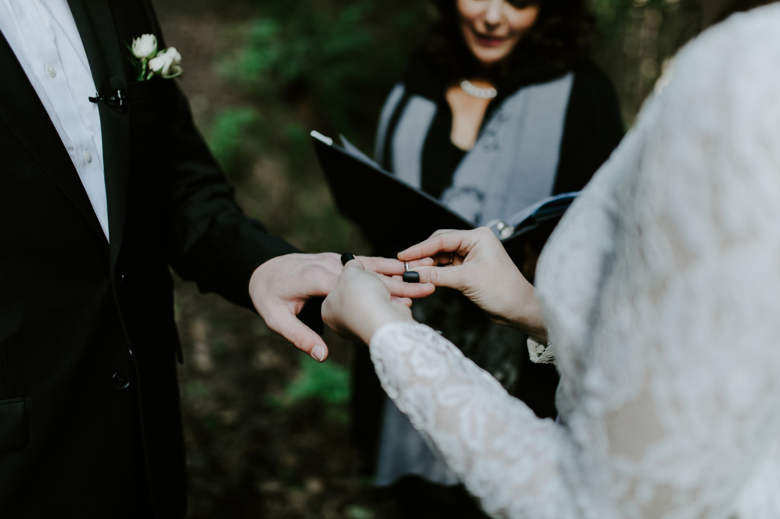 Nicole and Vlad put rings on their fingers during their elopement. Elopement wedding photography at Cannon Beach by Sienna Plus Josh.