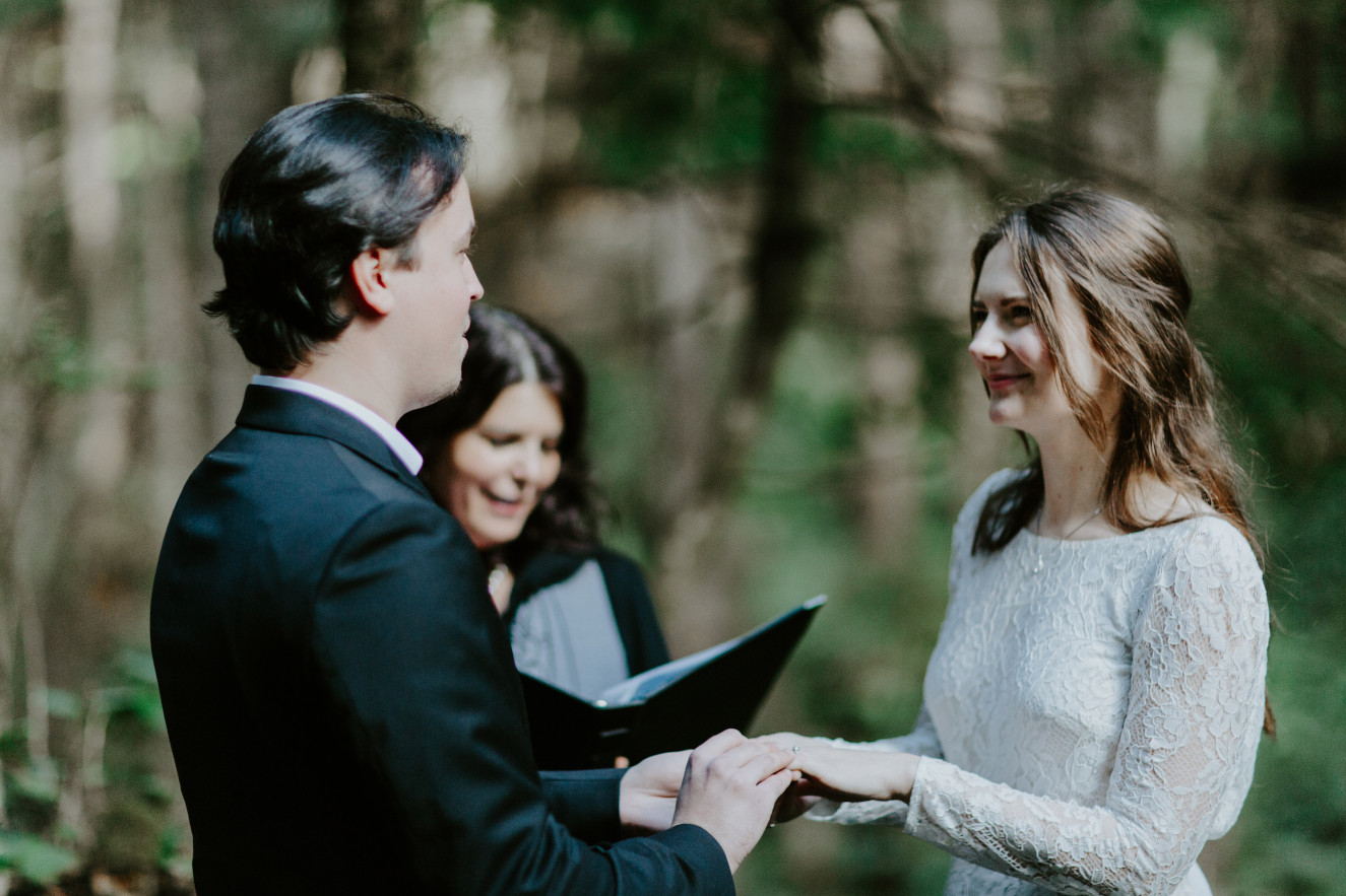 Nicole and Vlad exchange rings while reciting their final vow. Elopement wedding photography at Cannon Beach by Sienna Plus Josh.