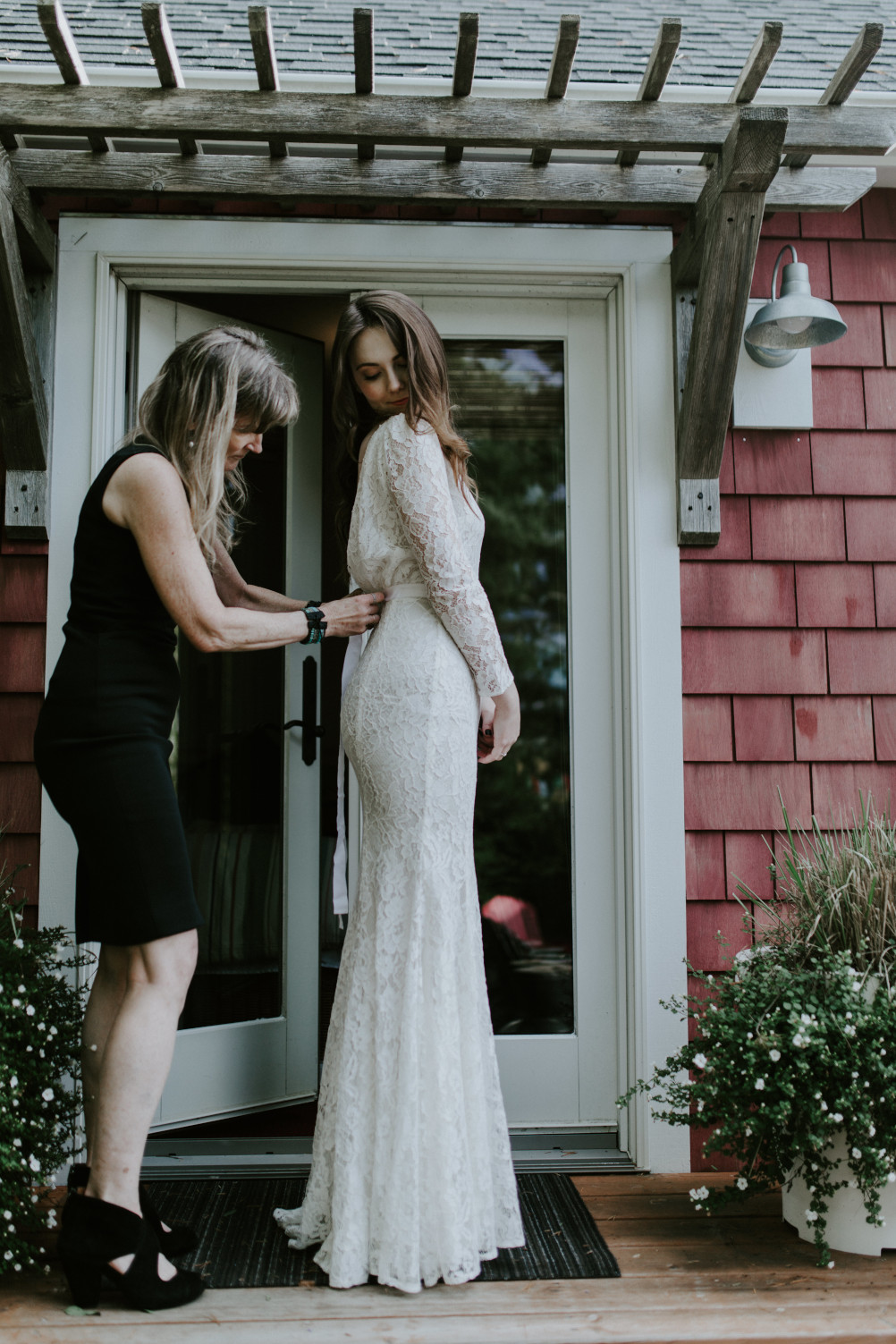 Nicole's mom helps her zip up her dress. Elopement wedding photography at Cannon Beach by Sienna Plus Josh.