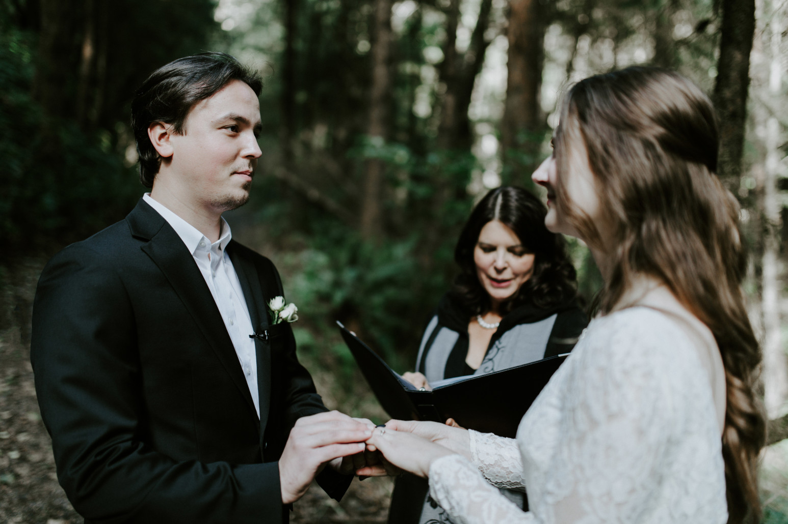 Vlad places a ring on Nicole's finger. Elopement wedding photography at Cannon Beach by Sienna Plus Josh.