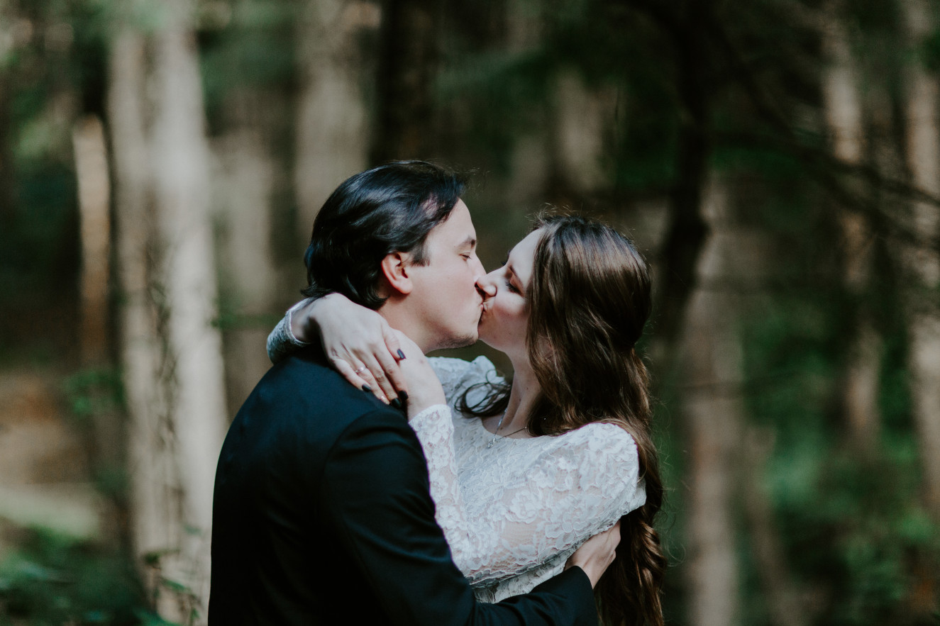 Nicole and Vlad kiss as they're announced husband and wife. Elopement wedding photography at Cannon Beach by Sienna Plus Josh.