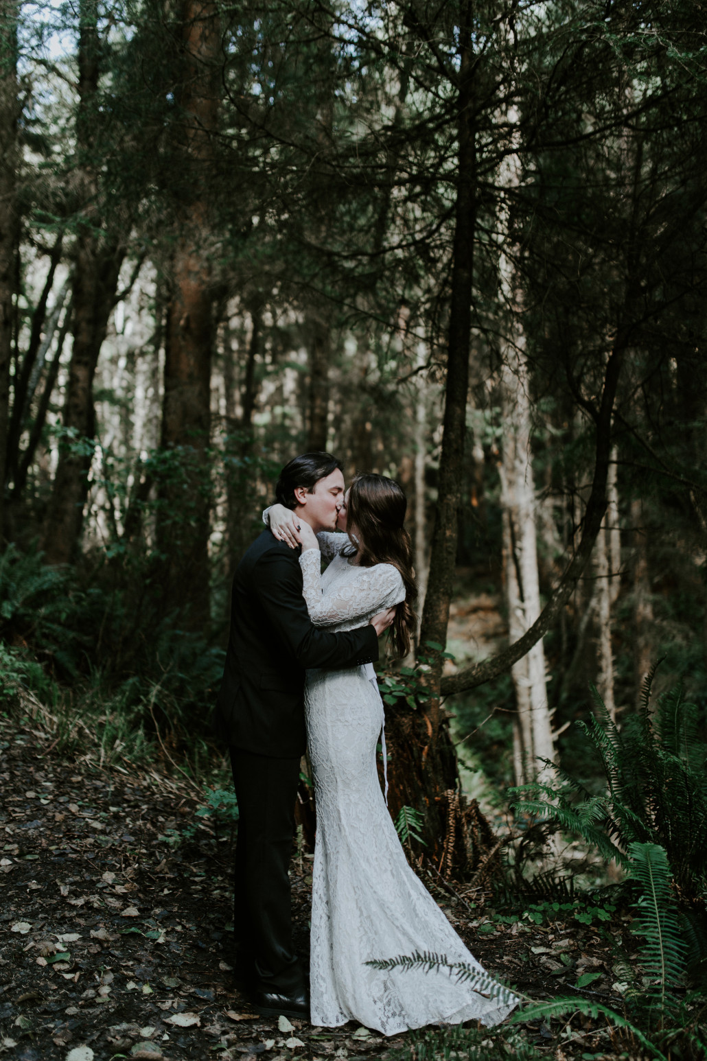 Nicole and Vlad seal their vows with a kiss. Elopement wedding photography at Cannon Beach by Sienna Plus Josh.