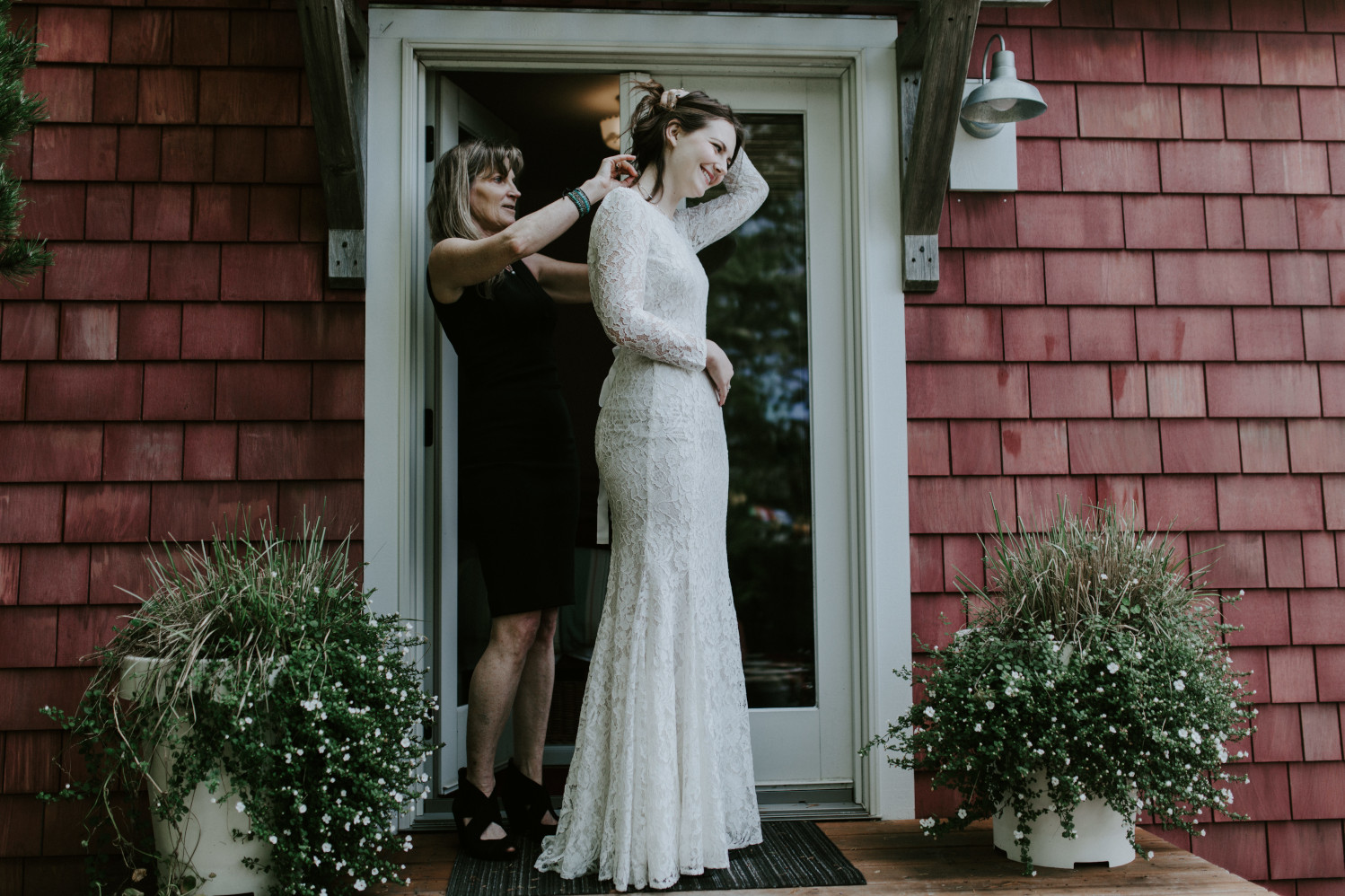 Nicole's mom helps finish the dress. Elopement wedding photography at Cannon Beach by Sienna Plus Josh.
