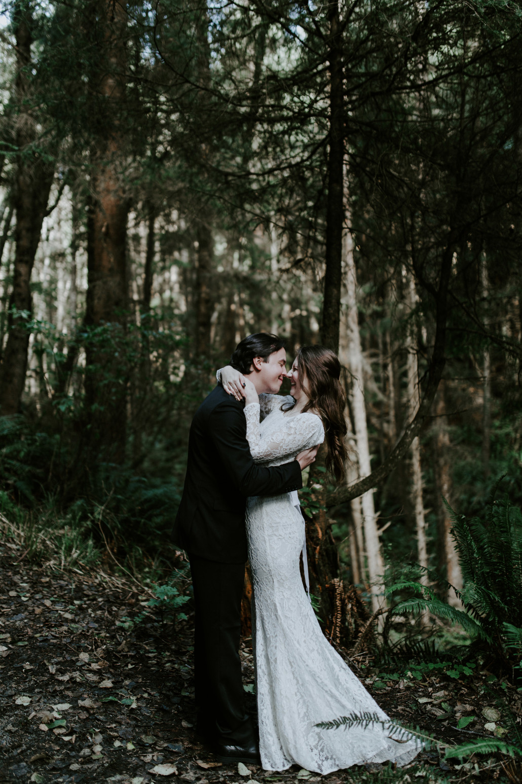 Nicole and Vlad smile at eachother at their elopement ceremony. Elopement wedding photography at Cannon Beach by Sienna Plus Josh.