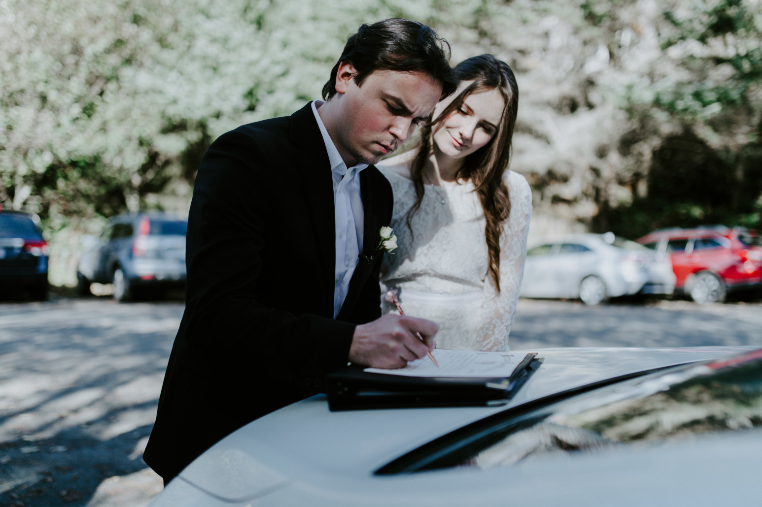 Nicole and Vlad sign their marriage certificate. Elopement wedding photography at Cannon Beach by Sienna Plus Josh.