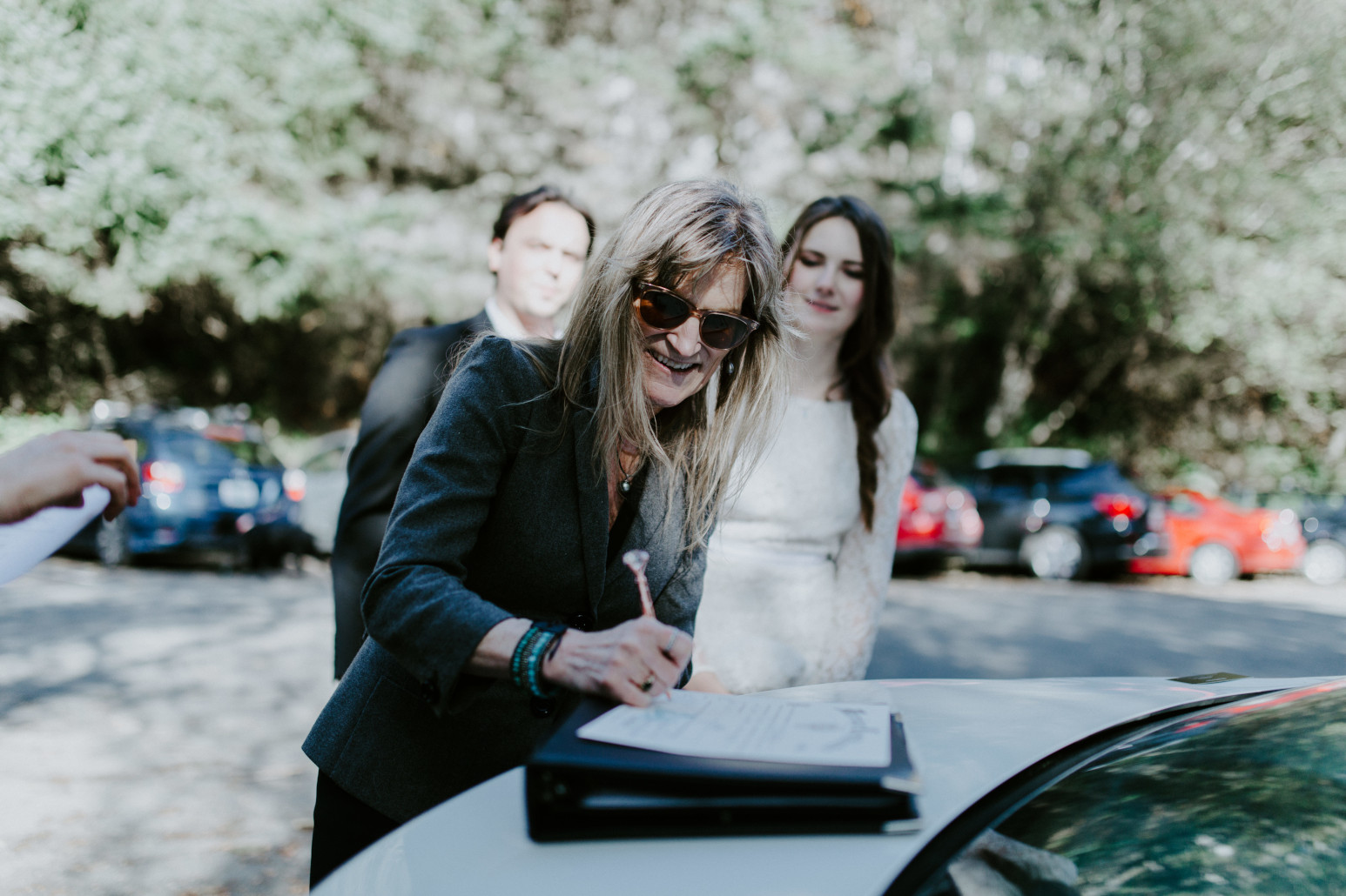 Nicole's mom signs the marriage certificate as a witness. Elopement wedding photography at Cannon Beach by Sienna Plus Josh.