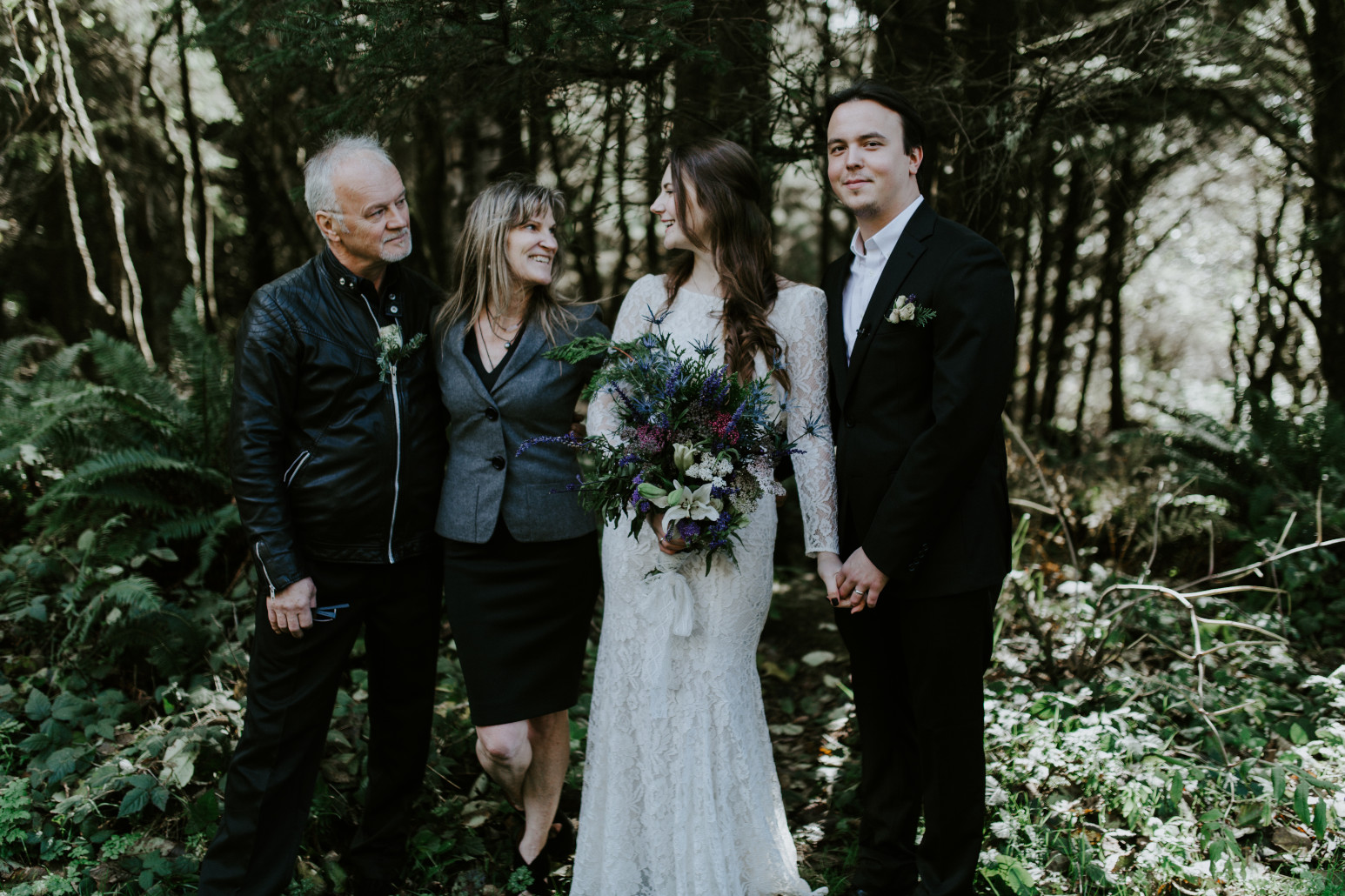 Nicole and Vlad stand with Nicole's parents. Elopement wedding photography at Cannon Beach by Sienna Plus Josh.